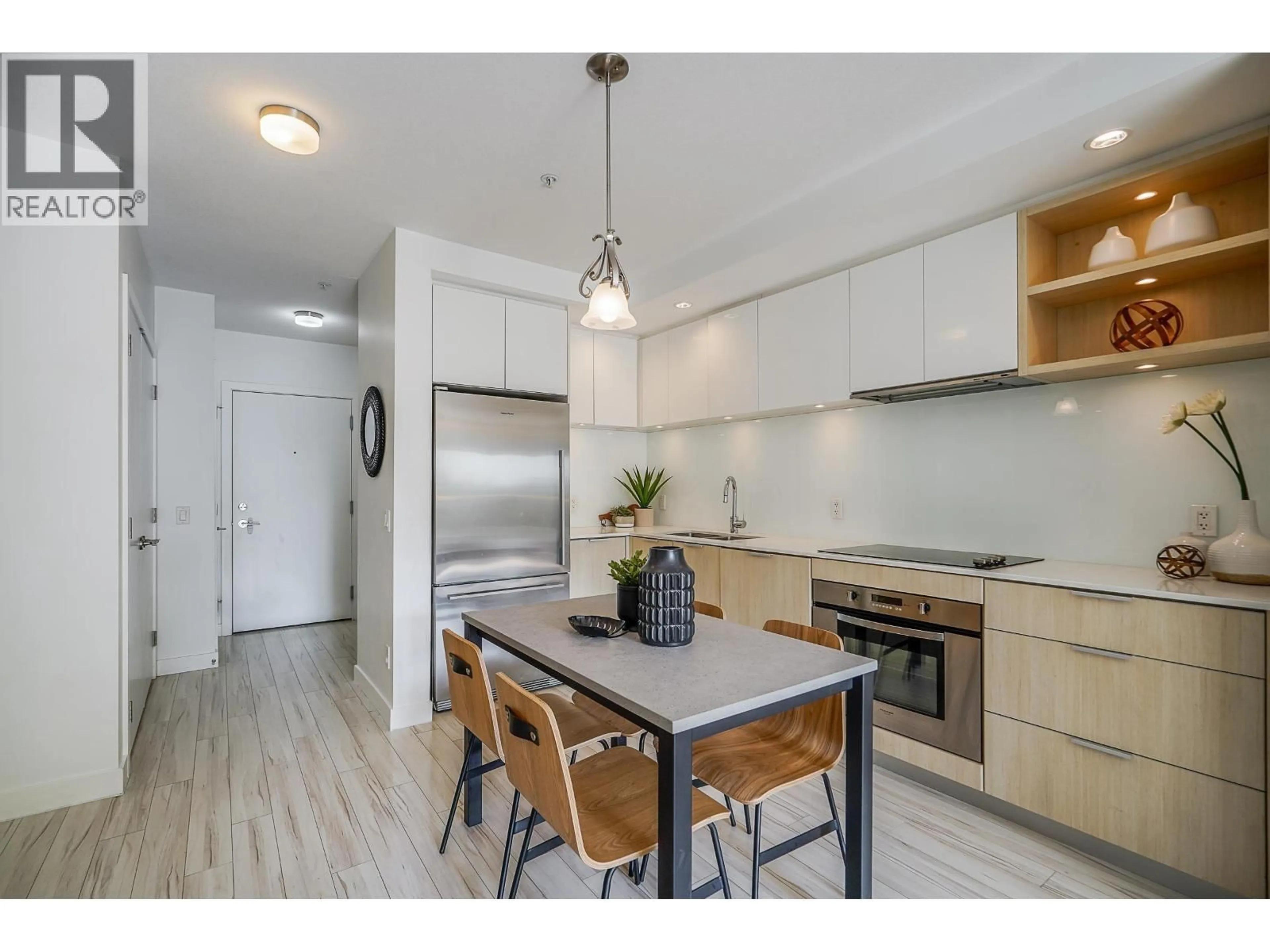 Open concept kitchen, wood/laminate floor for 214 - 111 E 3RD STREET, North Vancouver British Columbia V7L0C6