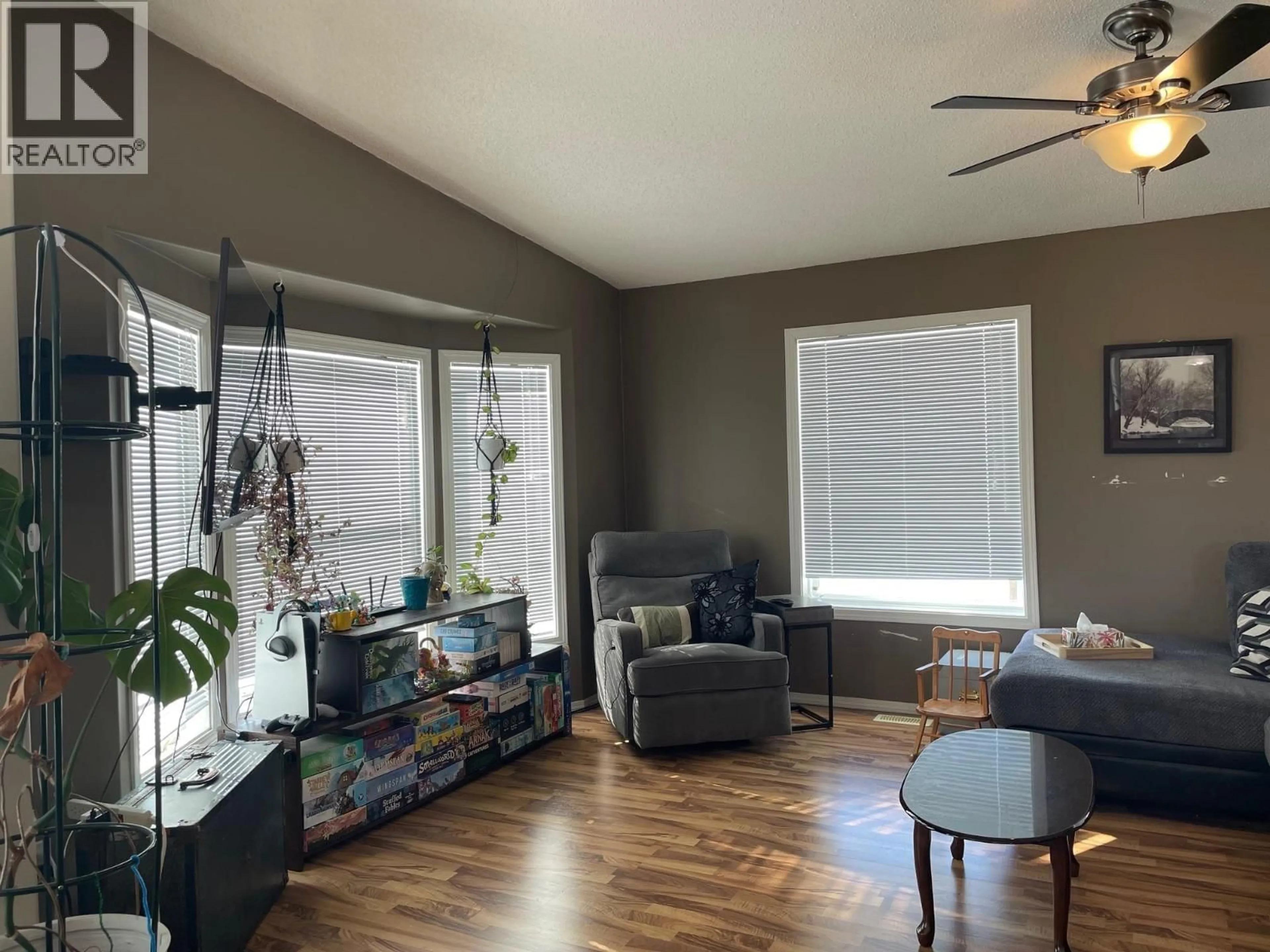 Living room with furniture, wood/laminate floor for 34 PEBBLE DRIVE, Fort Nelson British Columbia V0C1R0