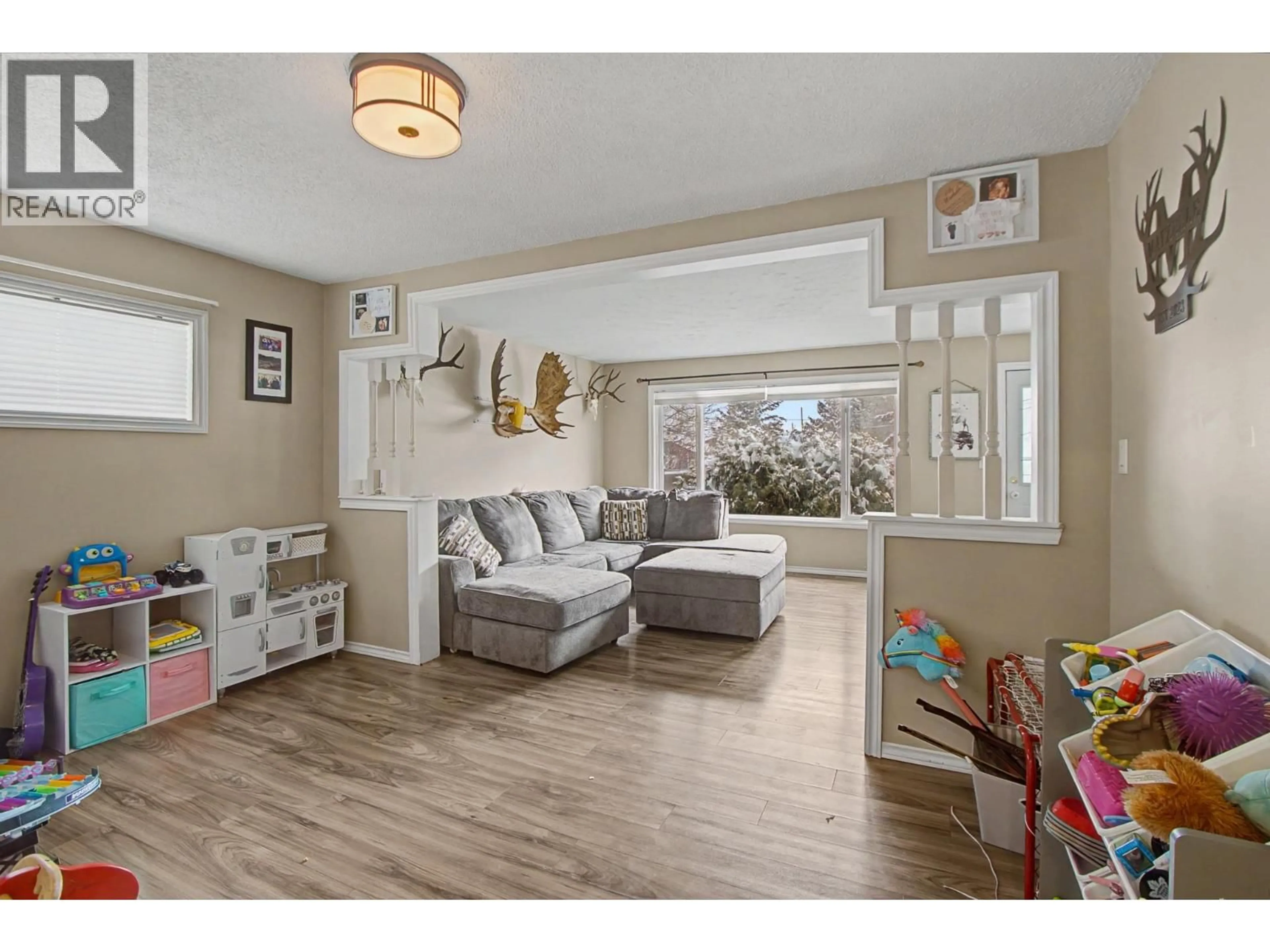 Living room with furniture, wood/laminate floor for 2422 MYTTING ROAD, Prince George British Columbia V2K1R7