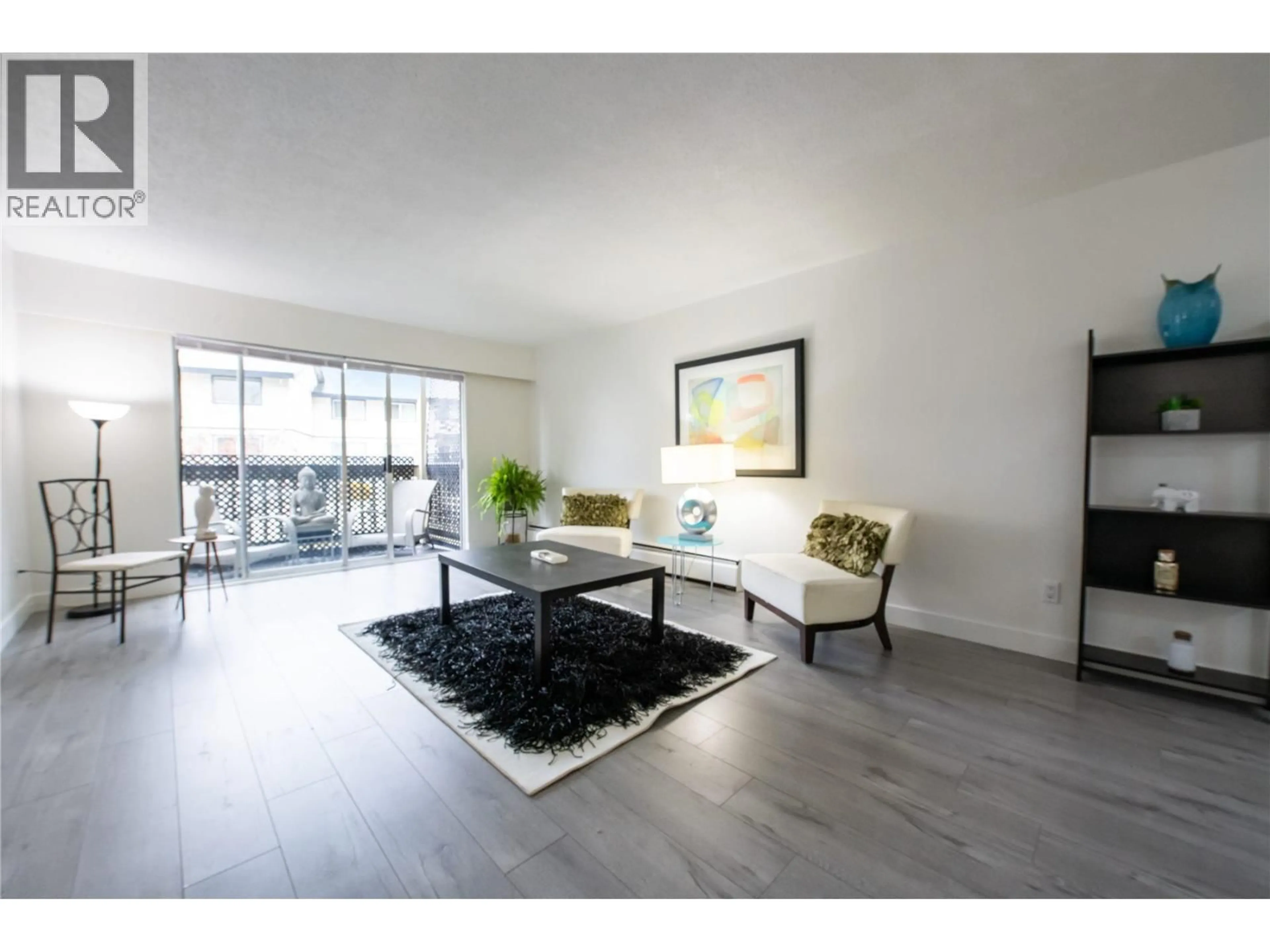 Living room with furniture, wood/laminate floor for 212 - 780 PREMIER STREET, North Vancouver British Columbia V7J2G8