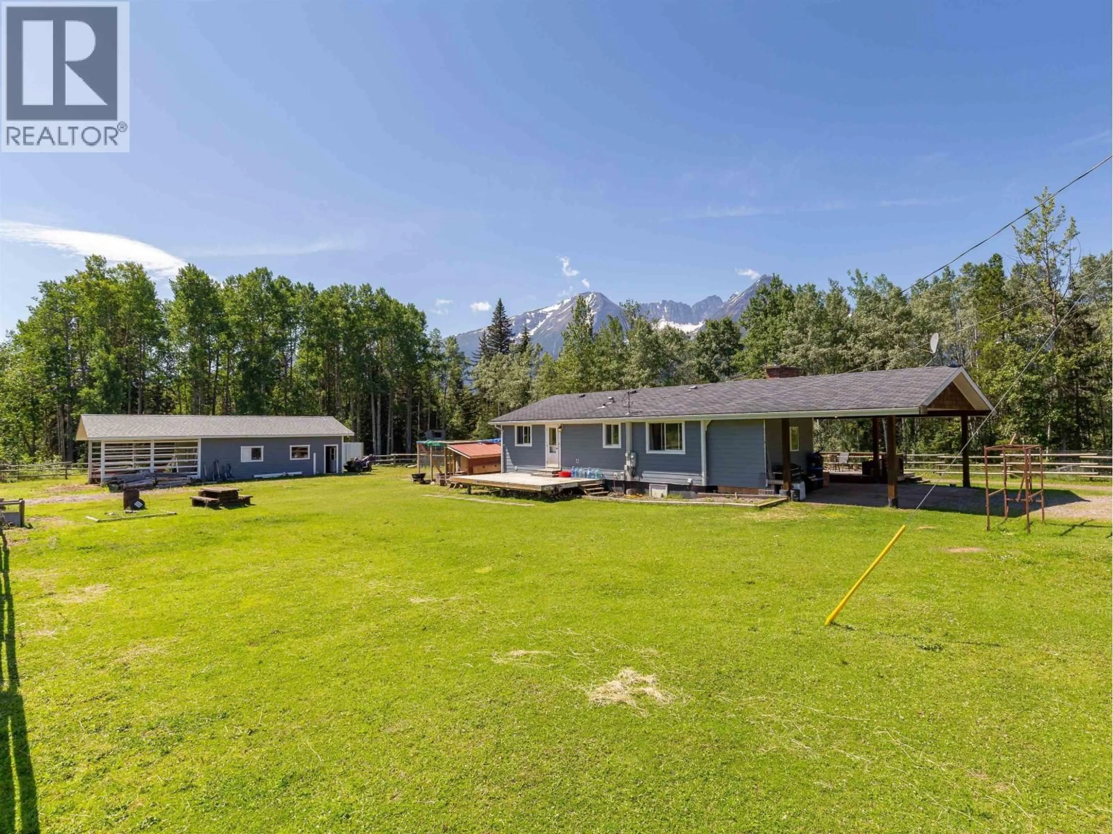 A pic from outside/outdoor area/front of a property/back of a property/a pic from drone, mountain view for 5933 RACEWAY ROAD, Smithers British Columbia V0J2N1
