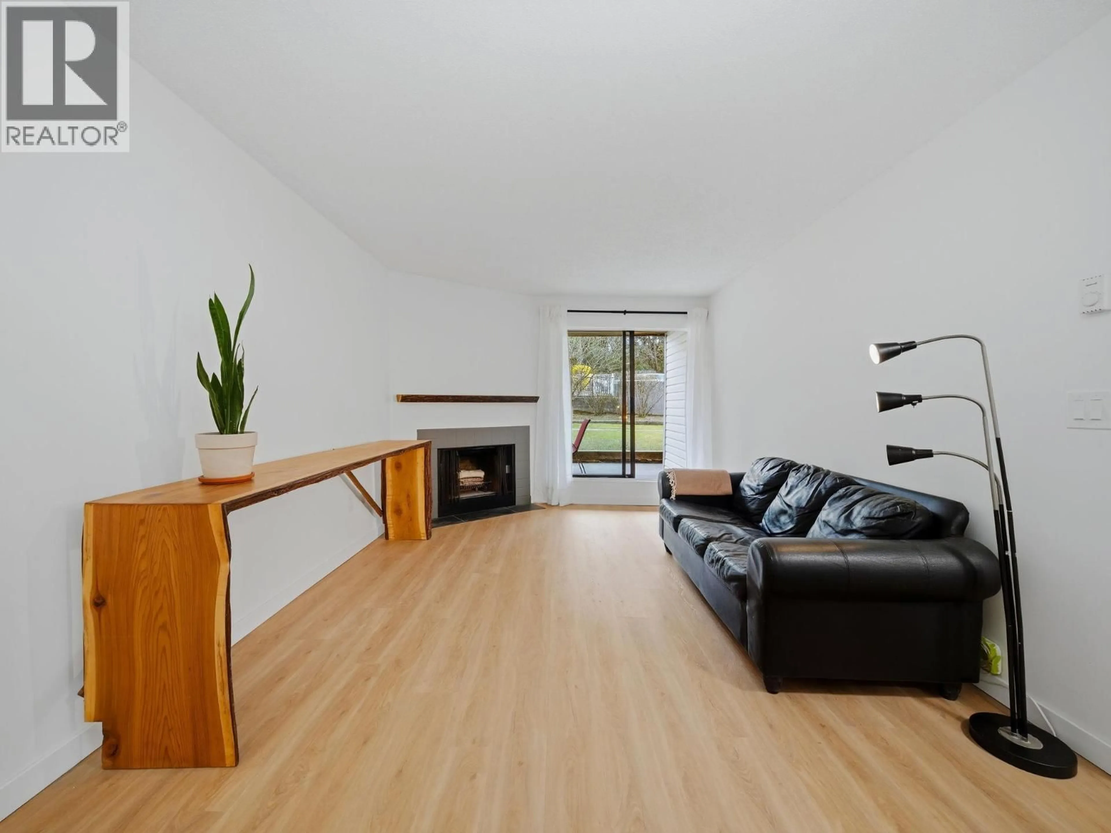 Living room with furniture, wood/laminate floor for 108 - 615 NORTH ROAD, Coquitlam British Columbia V3J1P1