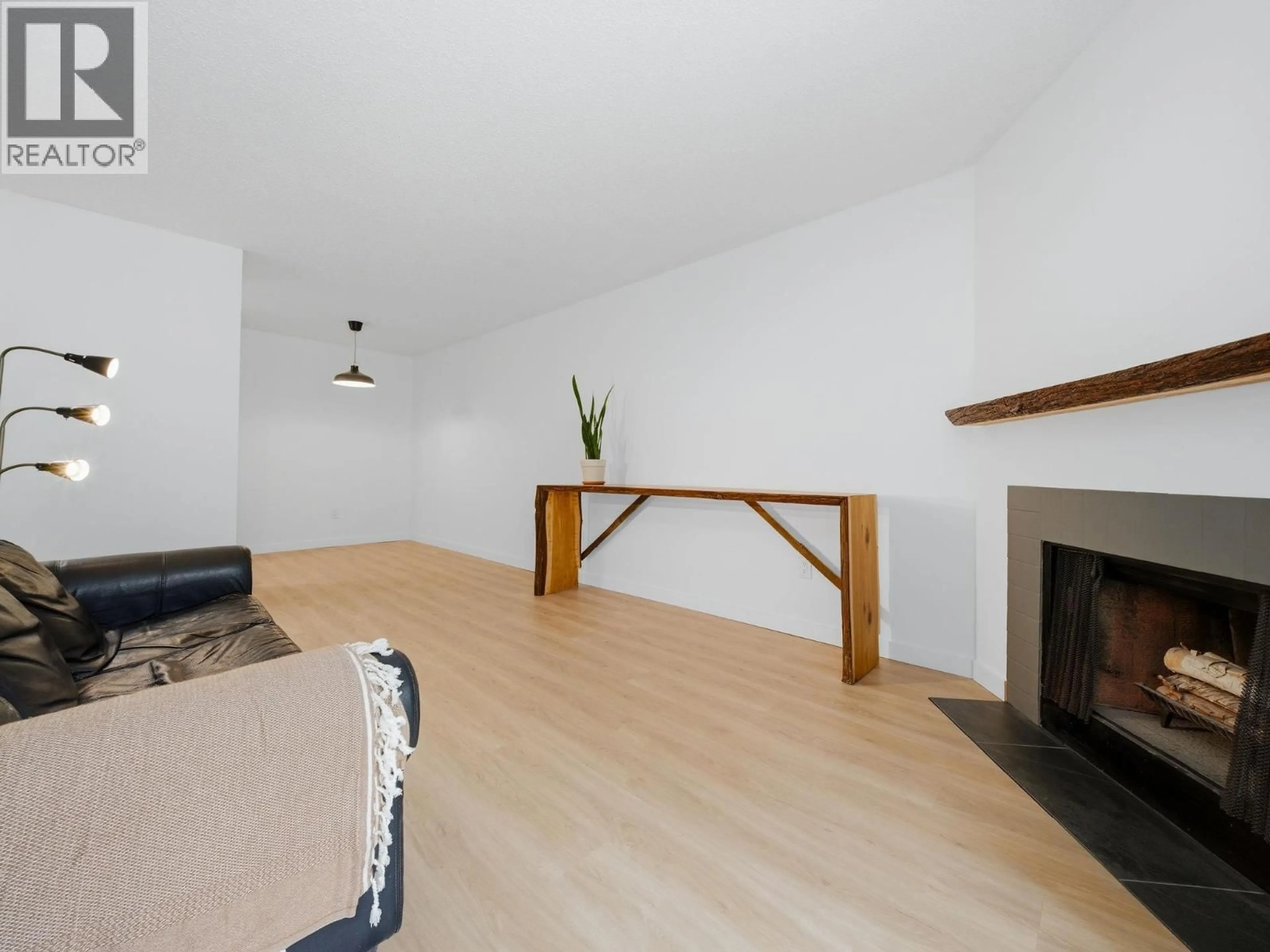 Living room with furniture, wood/laminate floor for 108 - 615 NORTH ROAD, Coquitlam British Columbia V3J1P1