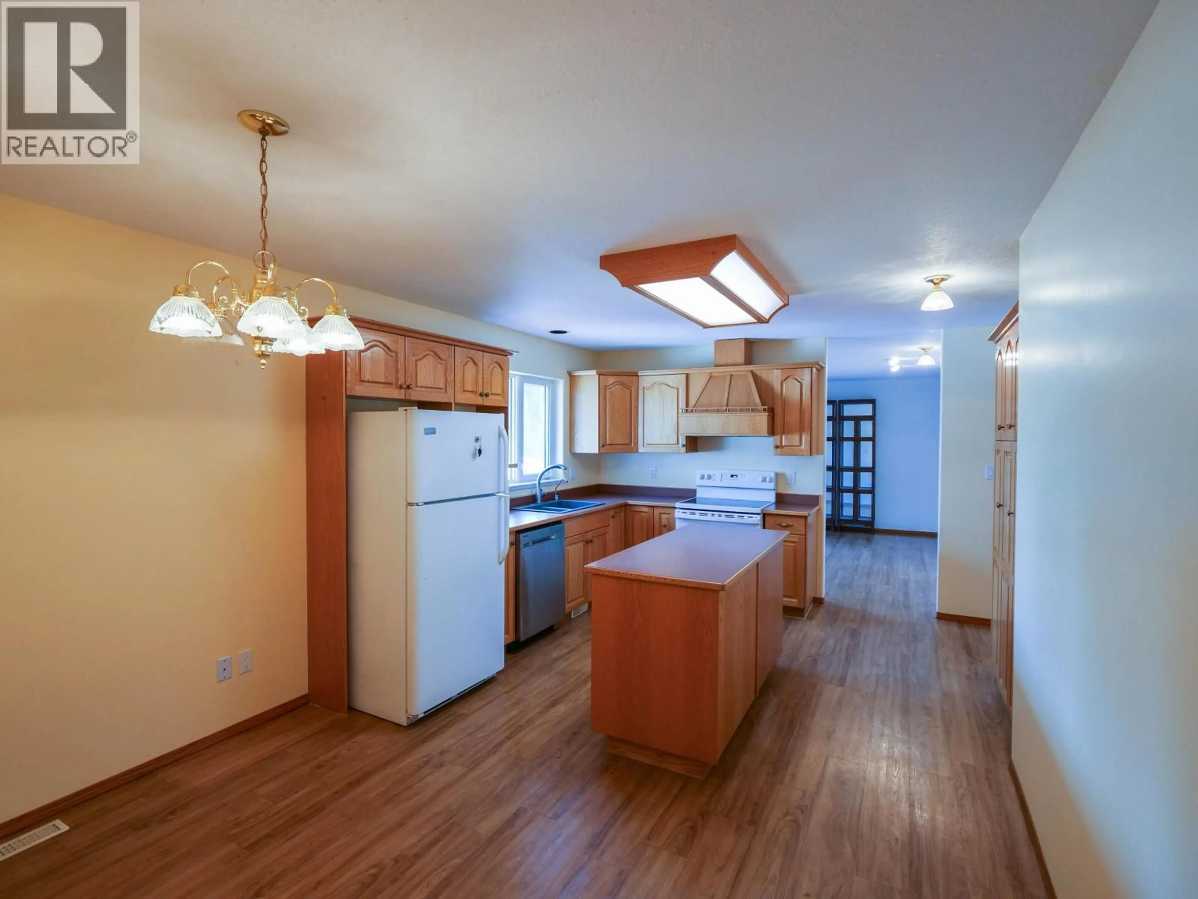Open concept kitchen, wood/laminate floor for 1889 ALMA ROAD, Quesnel British Columbia V2J6J3