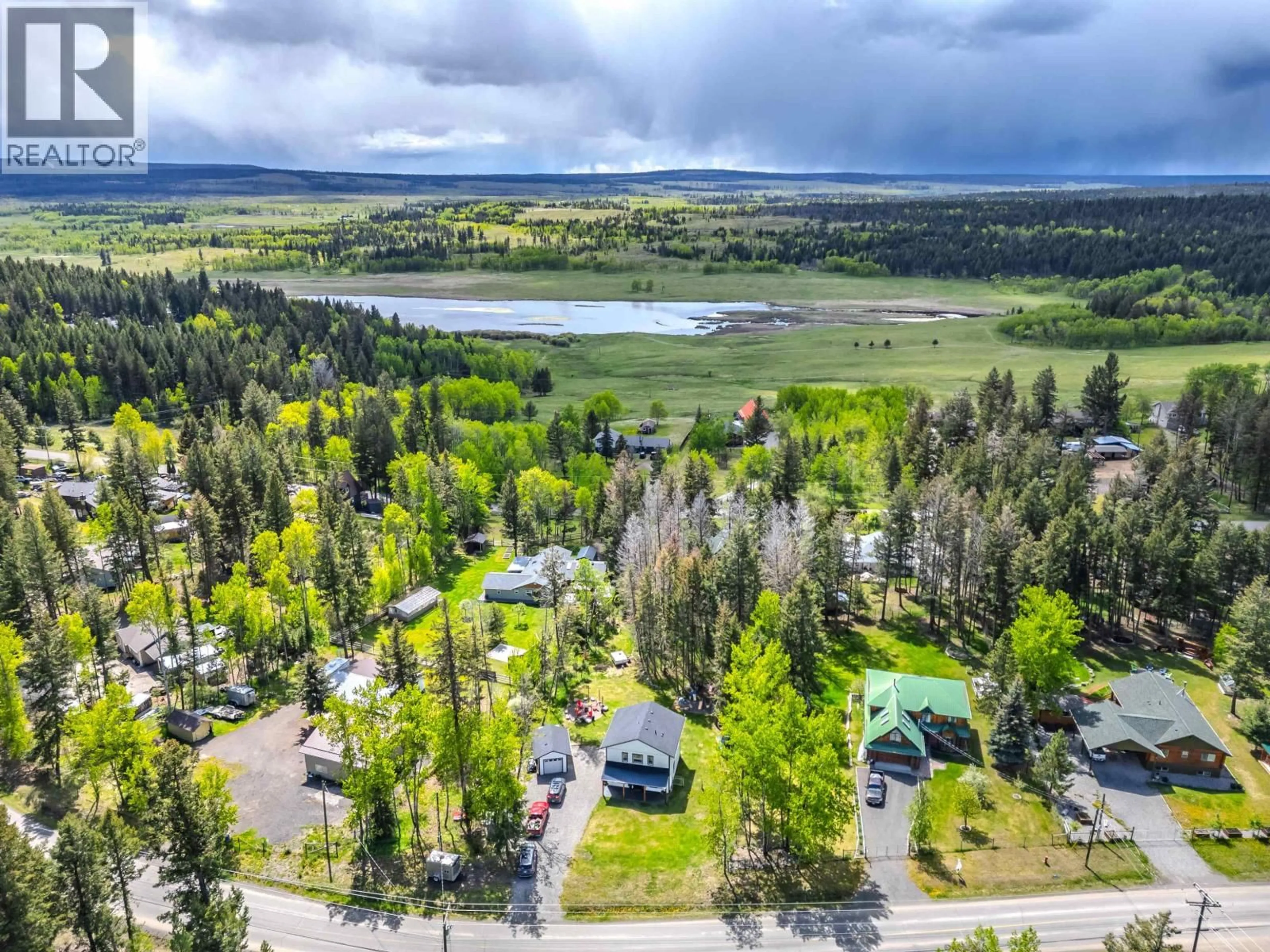 A pic from outside/outdoor area/front of a property/back of a property/a pic from drone, unknown for 4908 KITWANGA DRIVE, 108 Mile Ranch British Columbia V0K2Z0