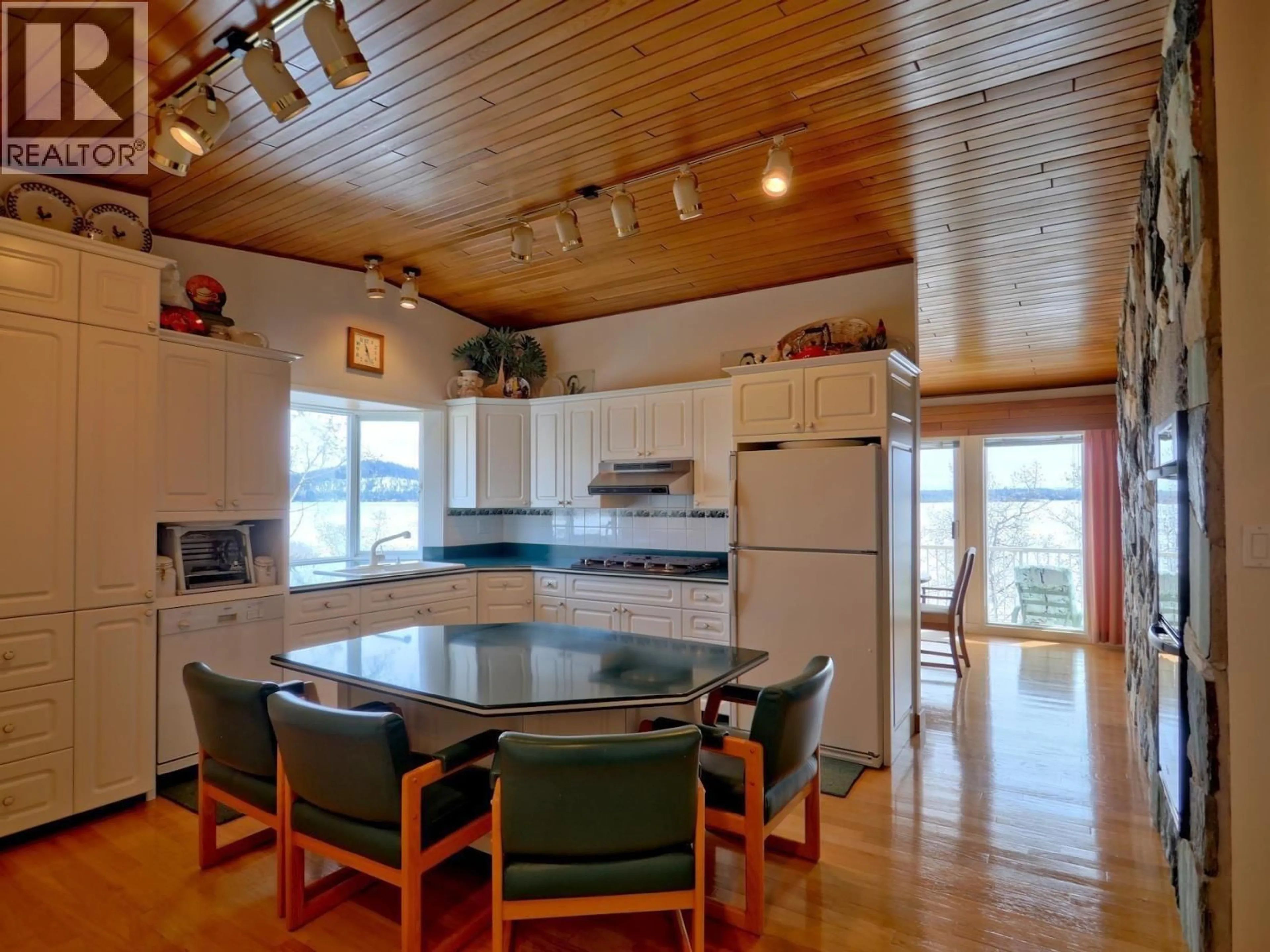 Open concept kitchen, wood/laminate floor for 5664 GREEN LAKE NORTH ROAD, 100 Mile House British Columbia V0K2K1