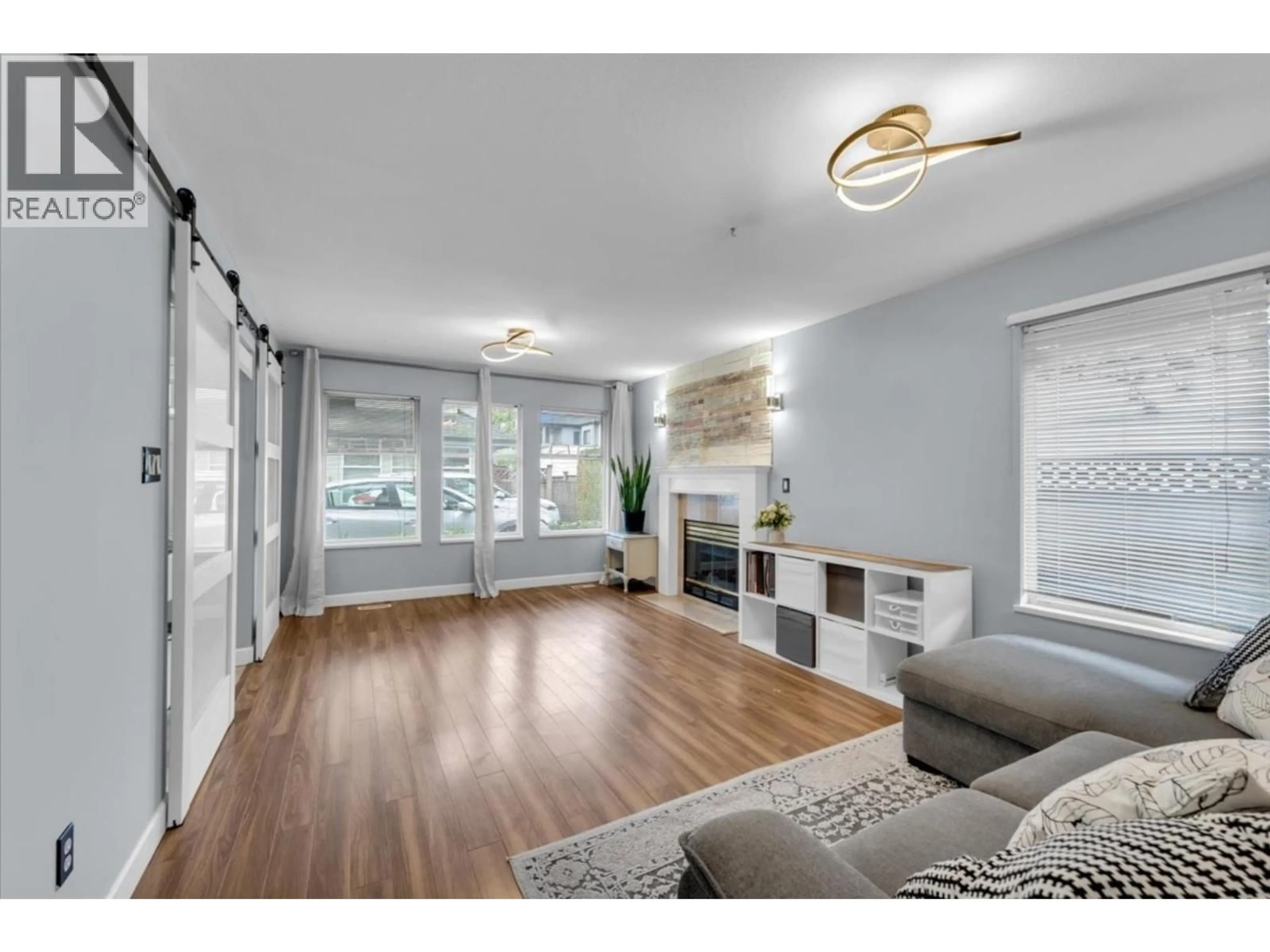 Living room with furniture, wood/laminate floor for 3 - 6675 NO. 2 ROAD, Richmond British Columbia V7C3L5