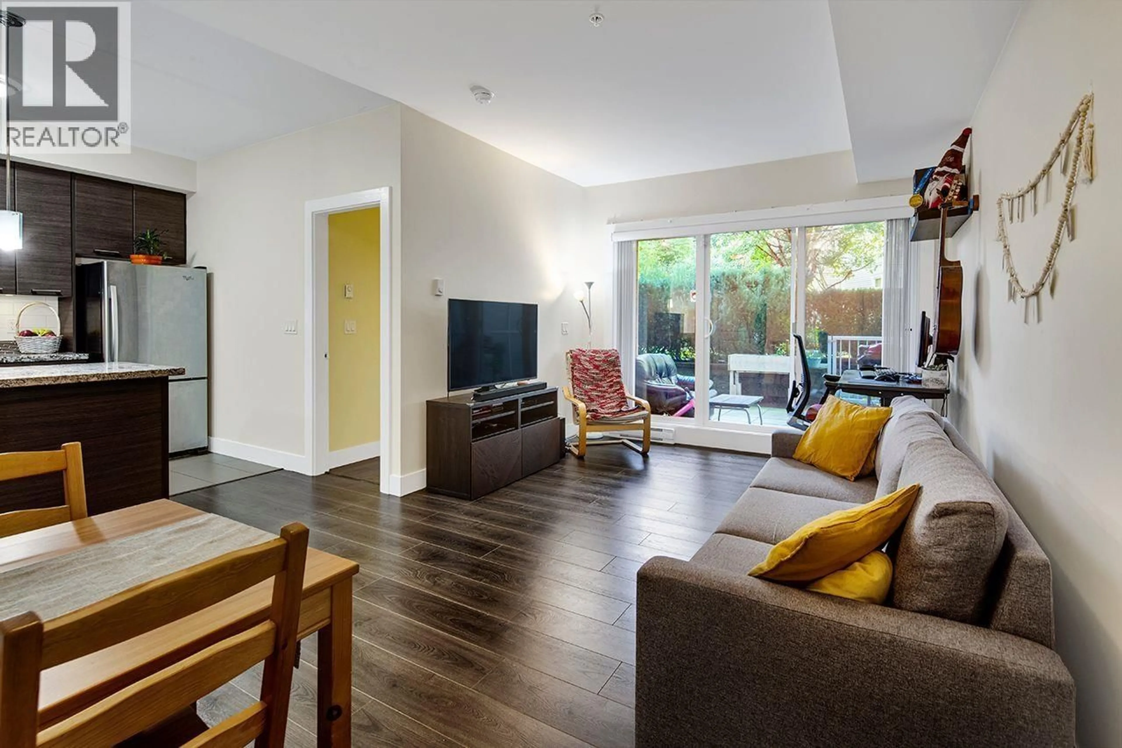 Living room with furniture, wood/laminate floor for 106 - 7377 14TH AVENUE, Burnaby British Columbia V3N1Z7