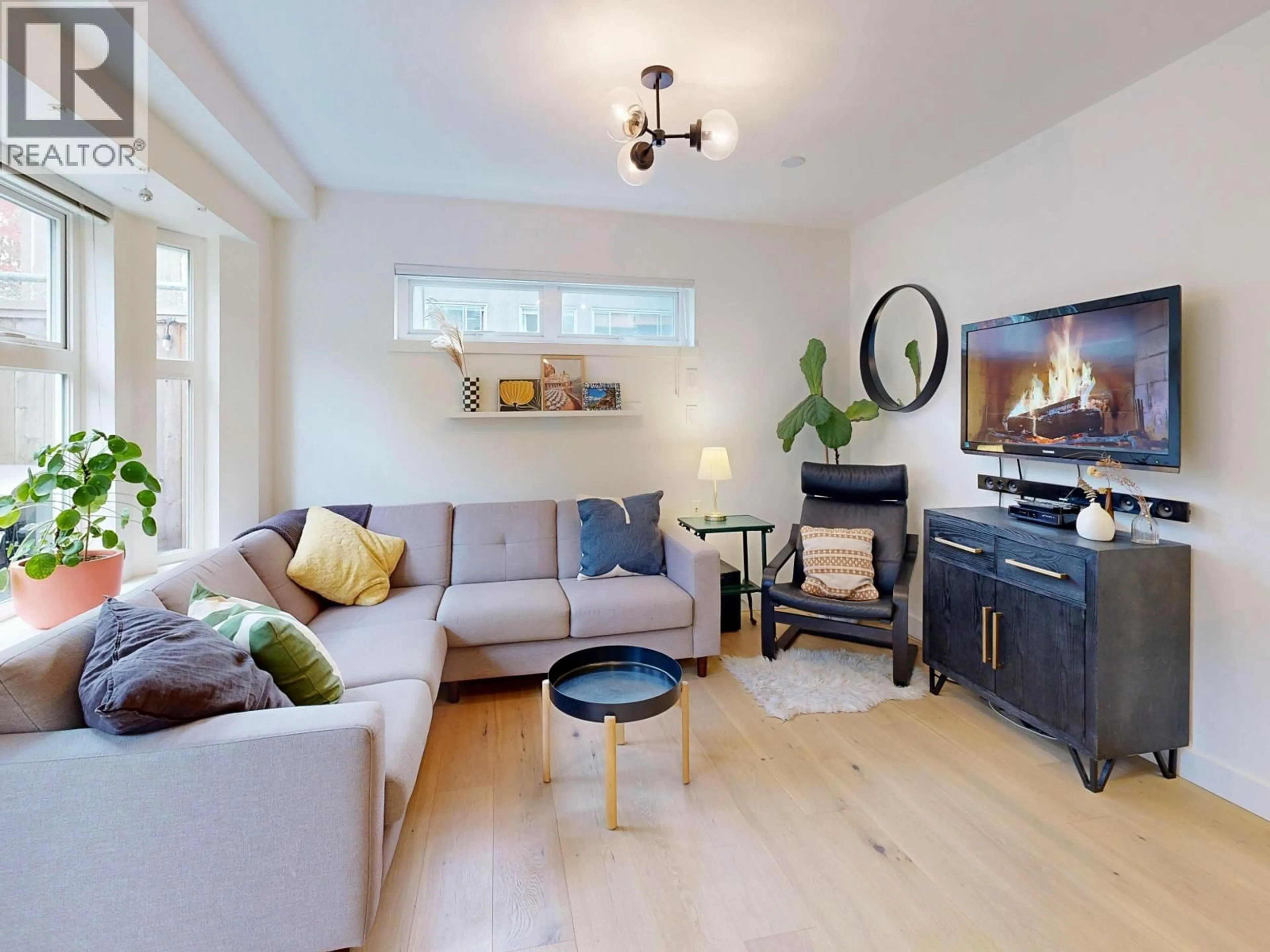 Living room with furniture, wood/laminate floor for 101 - 1672 PENDER STREET, Vancouver British Columbia V5L1W3