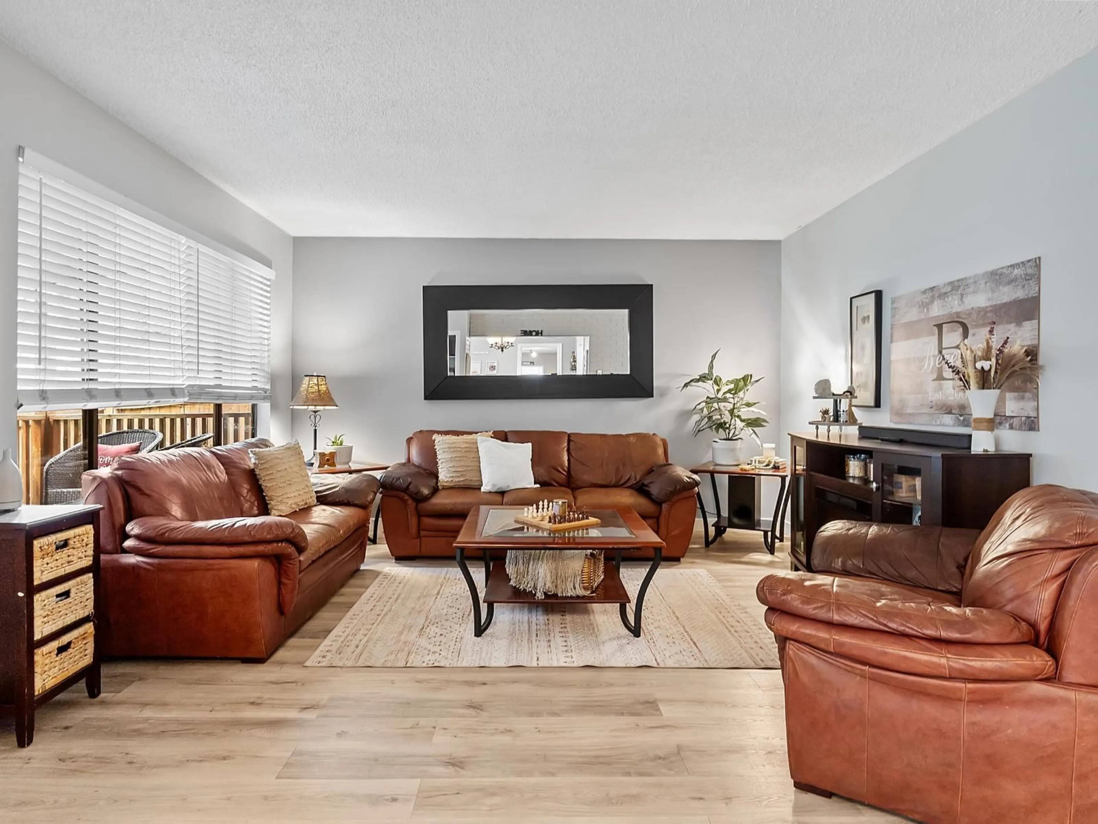 Living room with furniture, wood/laminate floor for 4552 200A STREET, Langley British Columbia V3A6J7