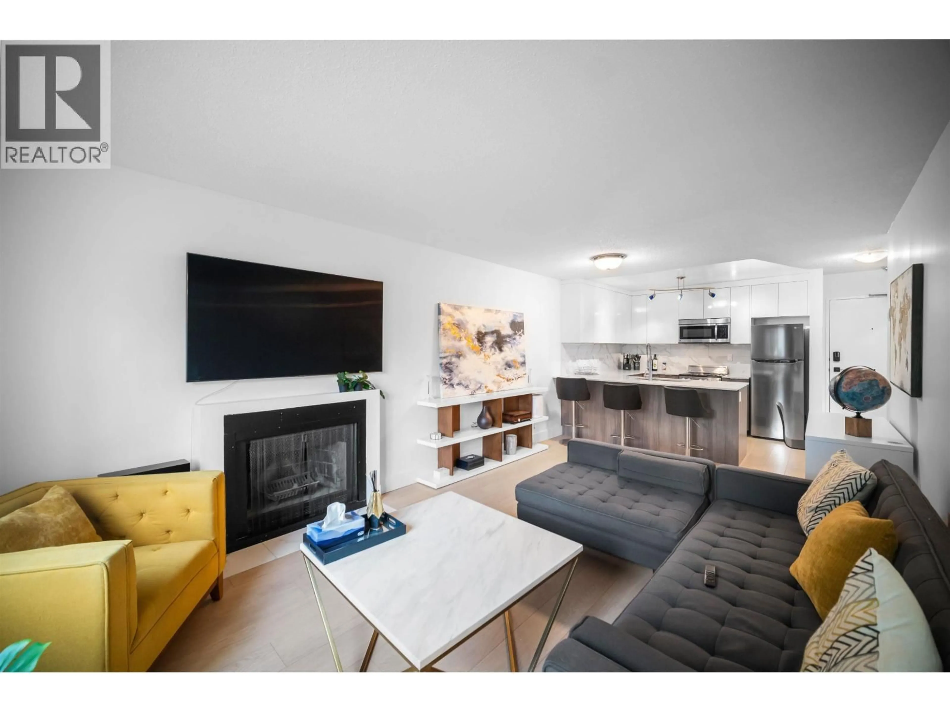 Living room with furniture, wood/laminate floor for 203 - 1122 KING ALBERT AVENUE, Coquitlam British Columbia V3J1X7