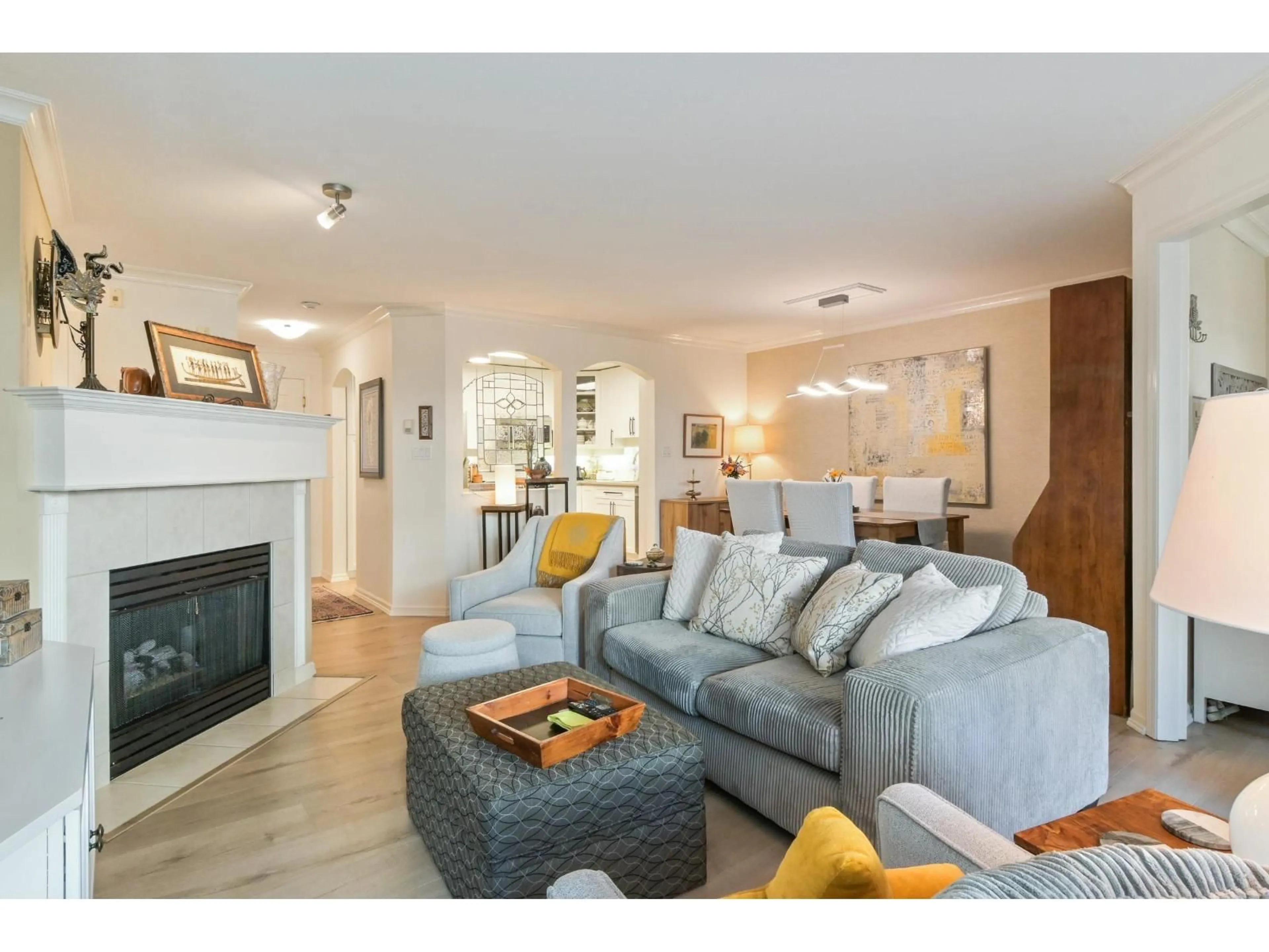 Living room with furniture, wood/laminate floor for 103 - 17727 58 AVENUE, Surrey British Columbia V3S1L5