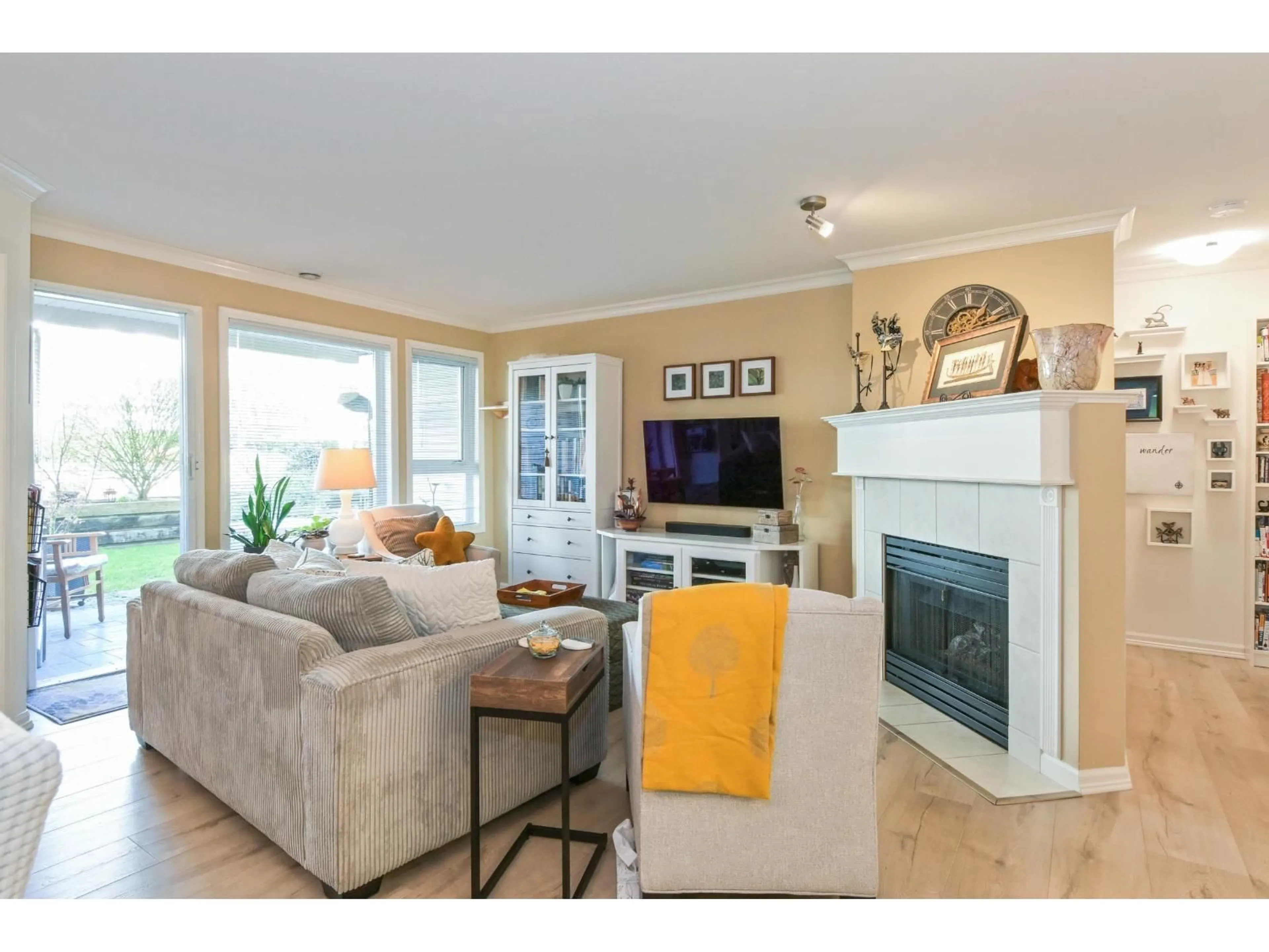 Living room with furniture, wood/laminate floor for 103 - 17727 58 AVENUE, Surrey British Columbia V3S1L5