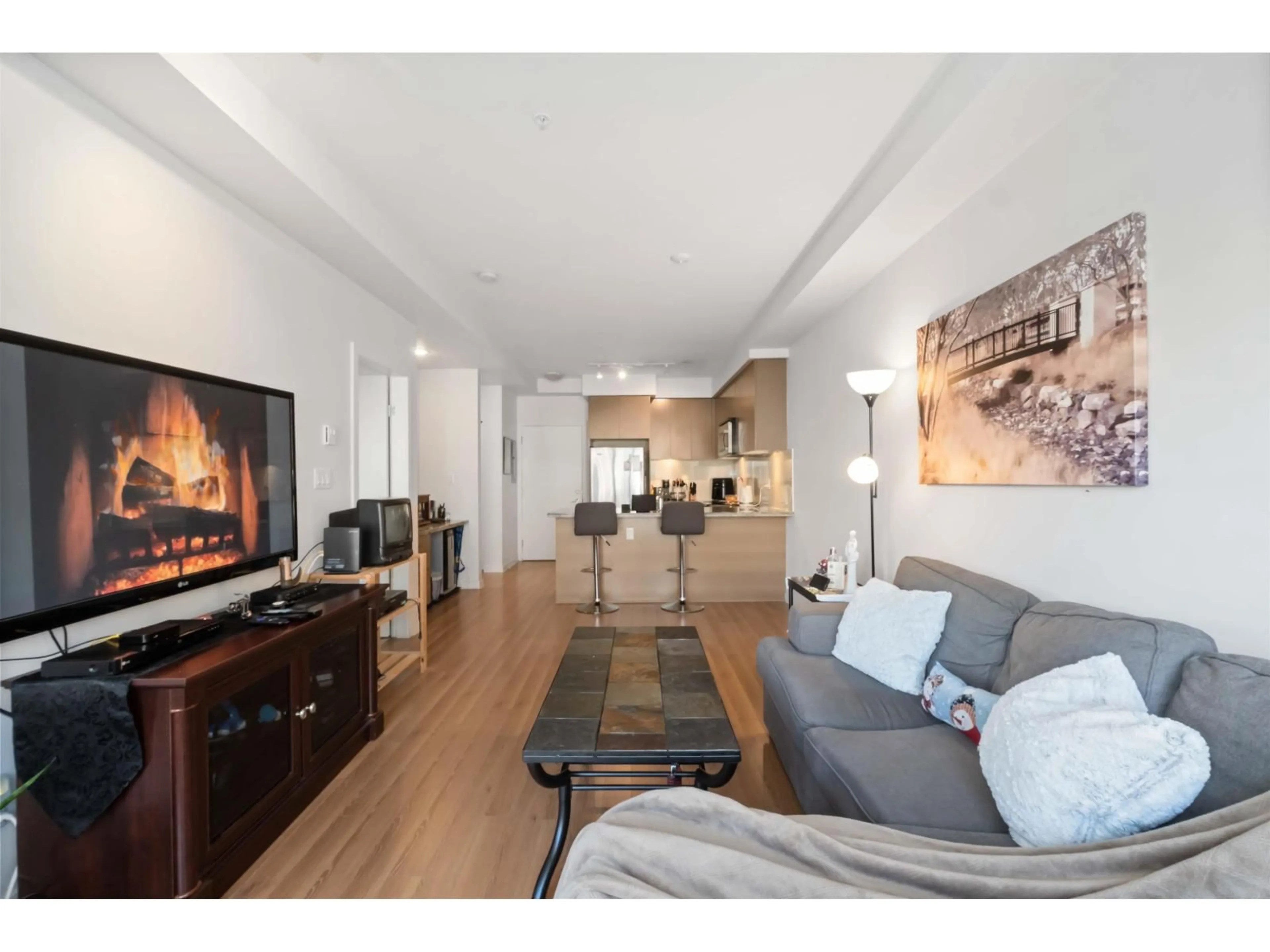 Living room with furniture, wood/laminate floor for 414 - 6440 194 STREET, Surrey British Columbia V4N6J7