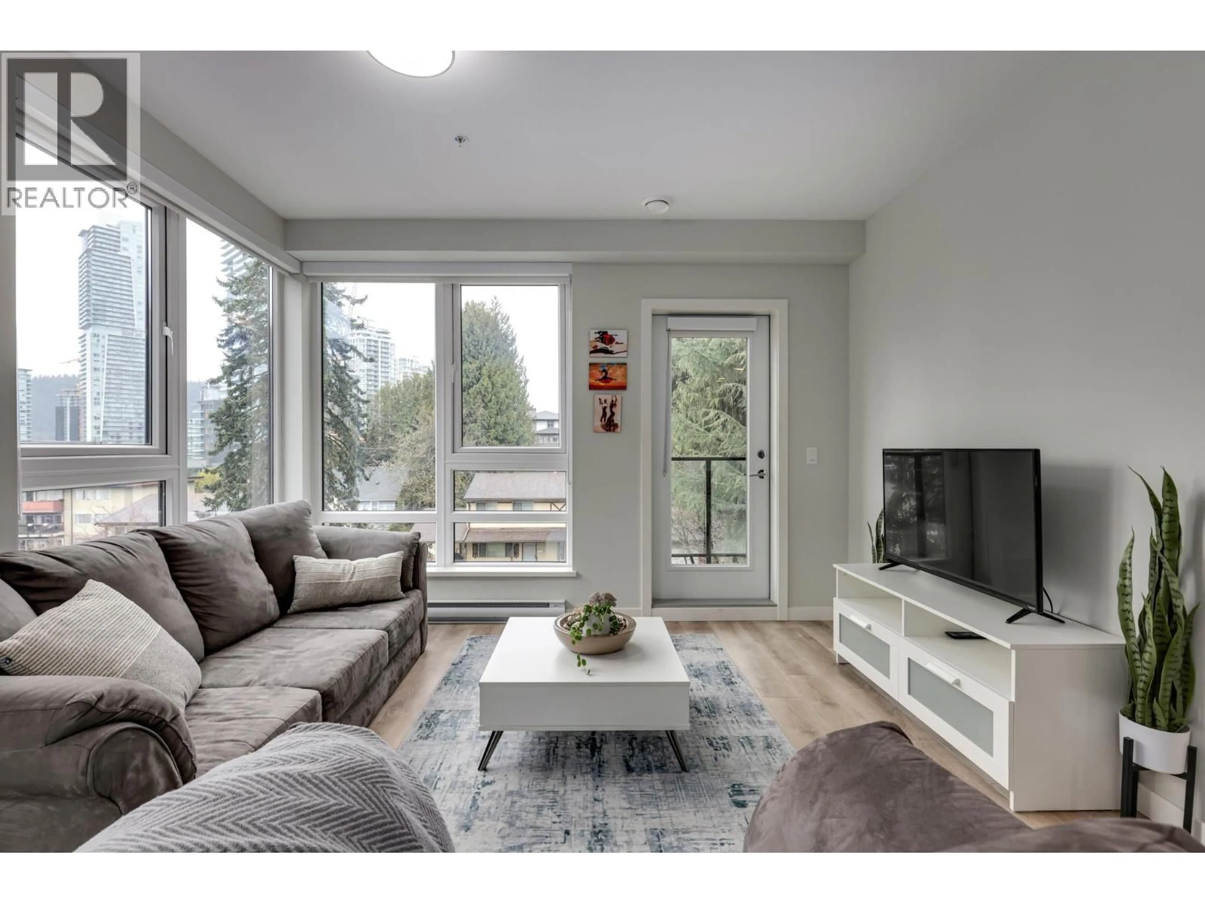 Living room with furniture, wood/laminate floor for 404 - 615 COTTONWOOD AVENUE, Coquitlam British Columbia V3J2S5