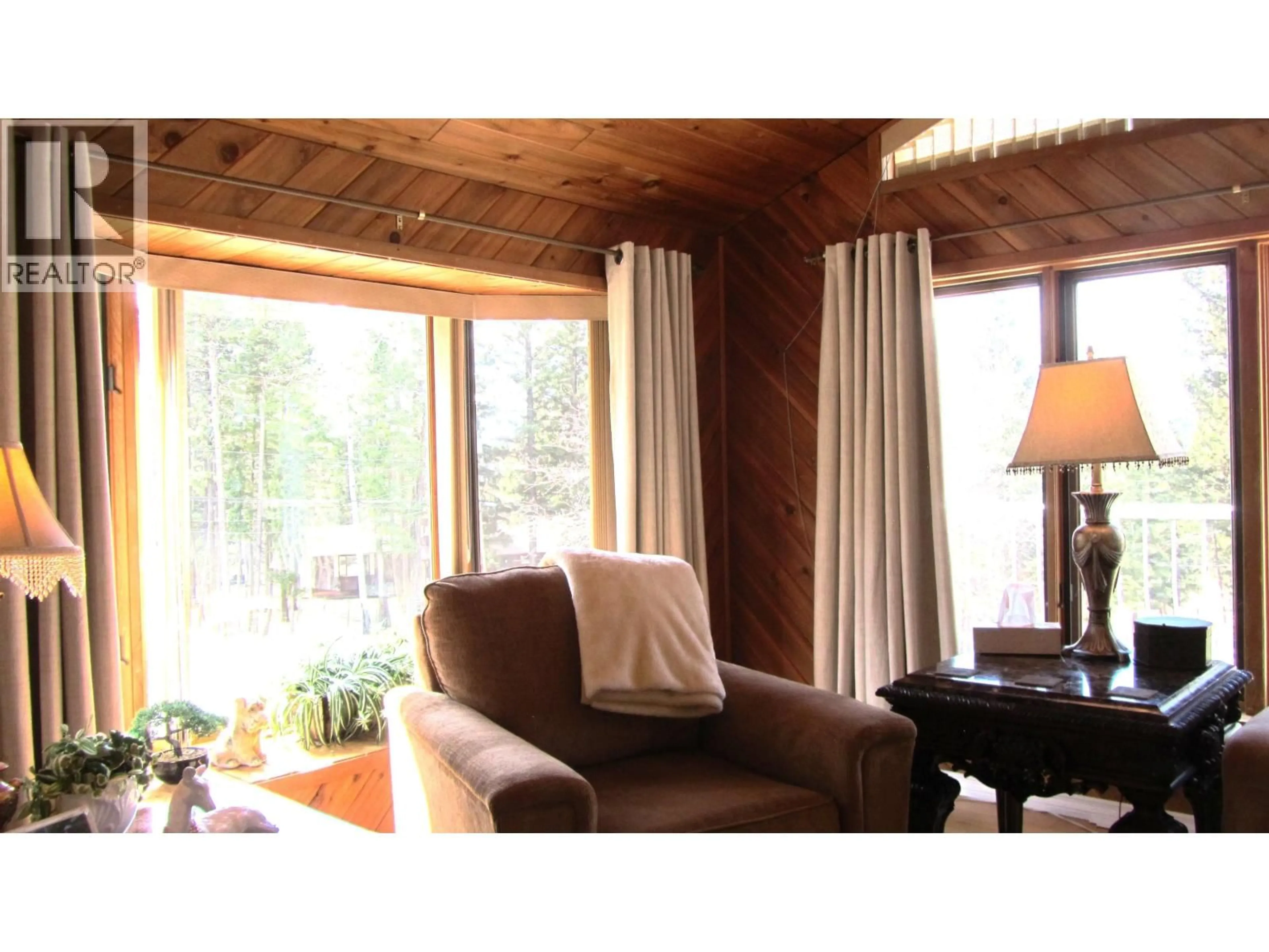 Living room with furniture, wood/laminate floor for 4827 KITWANGA DRIVE, 108 Mile Ranch British Columbia V0K2Z0