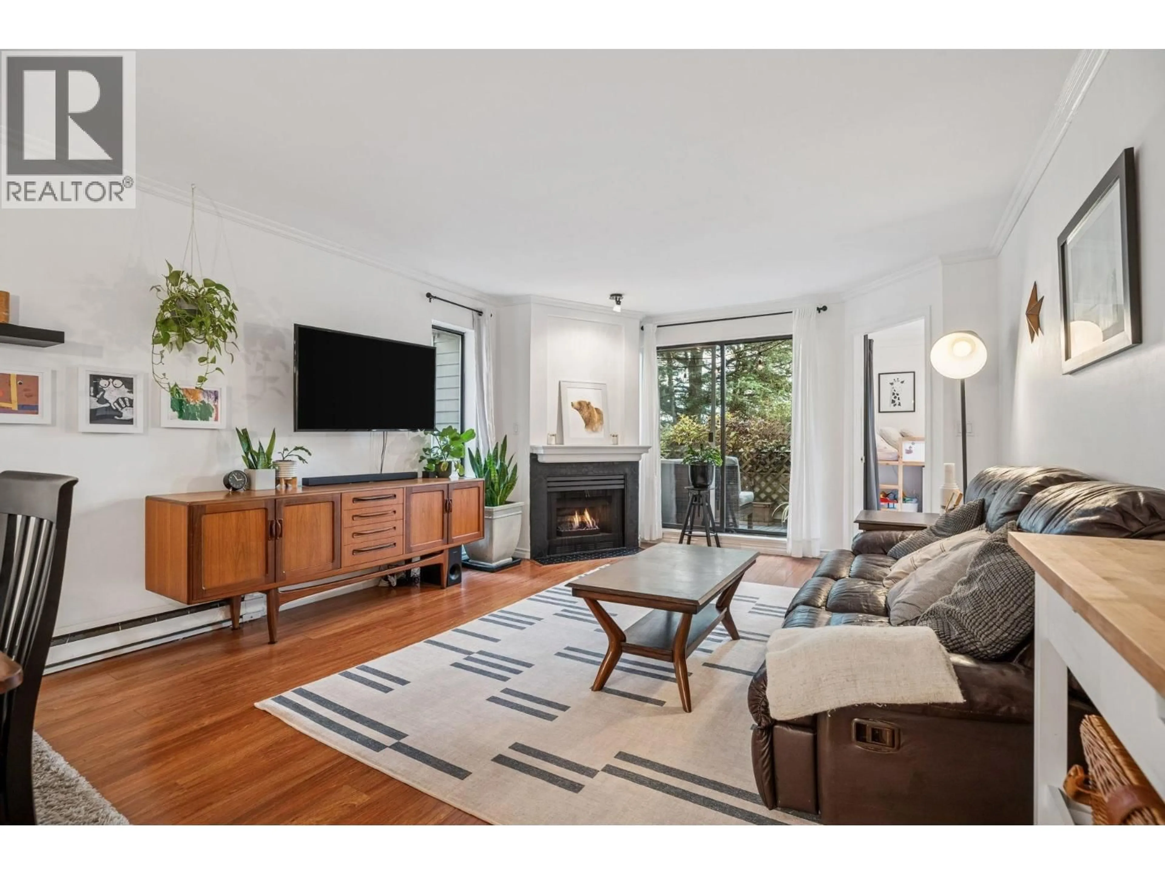 Living room with furniture, wood/laminate floor for 410 - 2925 GLEN DRIVE, Coquitlam British Columbia V3B7H9