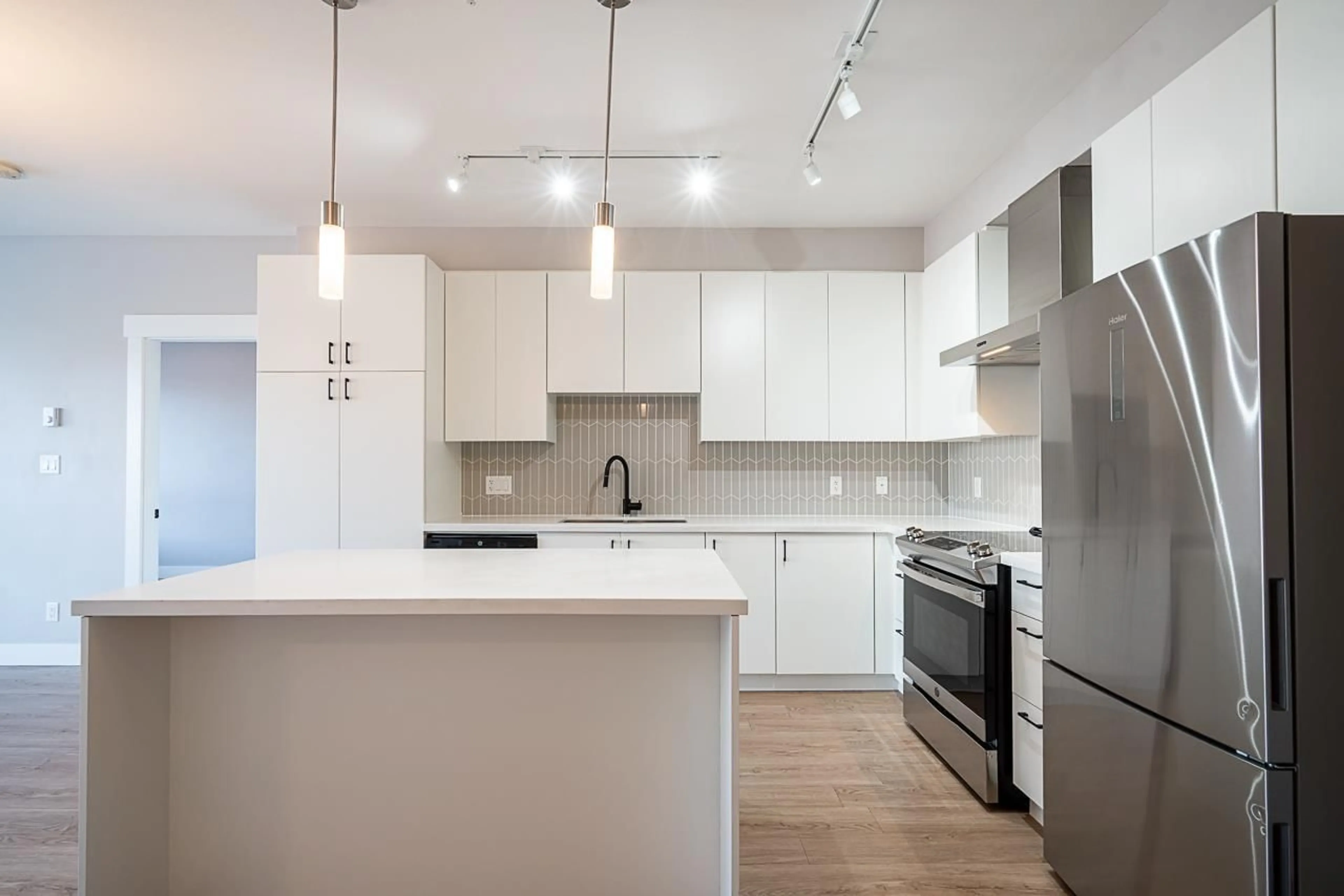 Open concept kitchen, wood/laminate floor for A310 - 20838 78B AVENUE, Langley British Columbia V2Y3M1