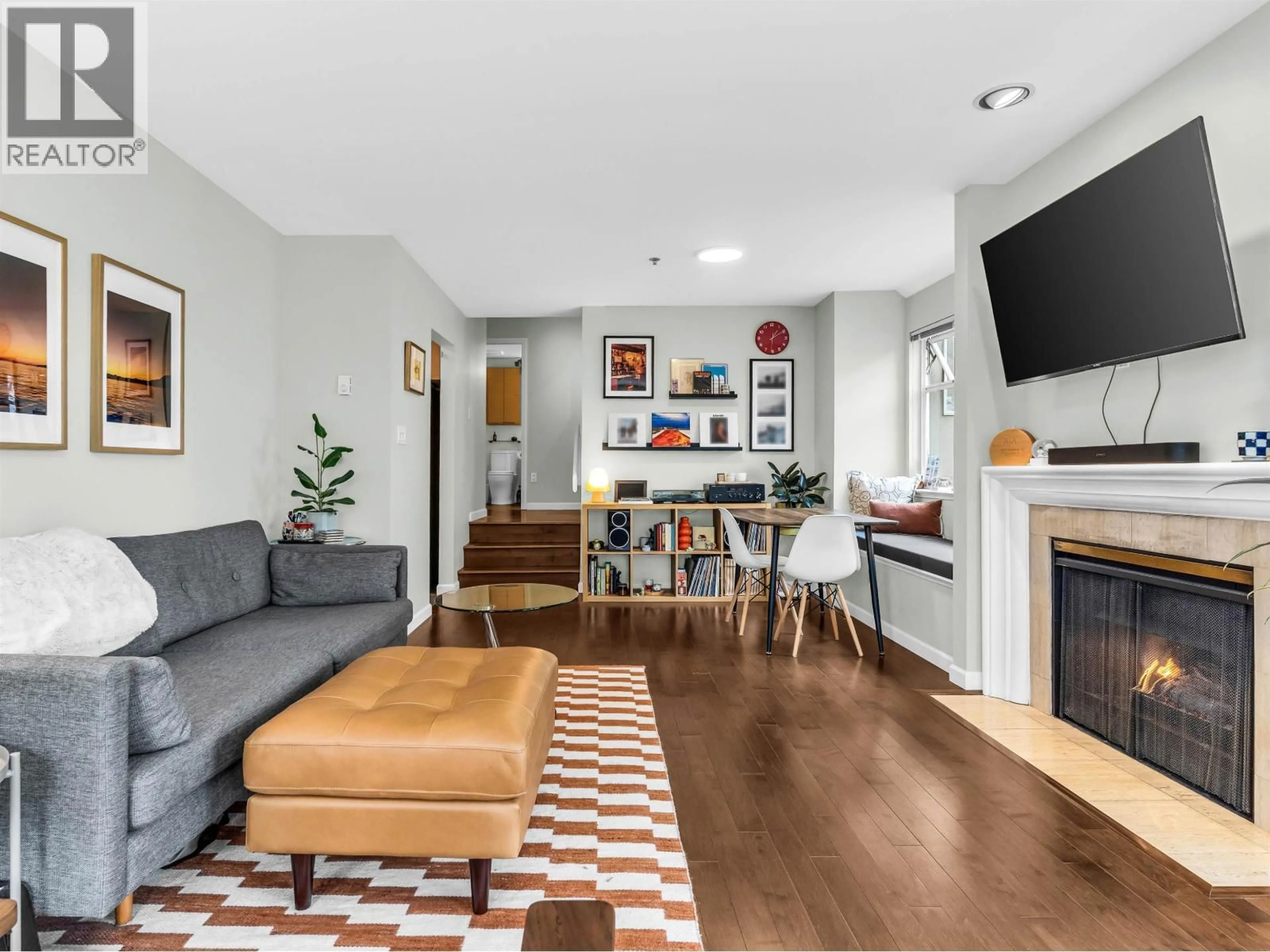 Living room with furniture, wood/laminate floor for 206 - 1963 3RD AVENUE, Vancouver British Columbia V6J1L2