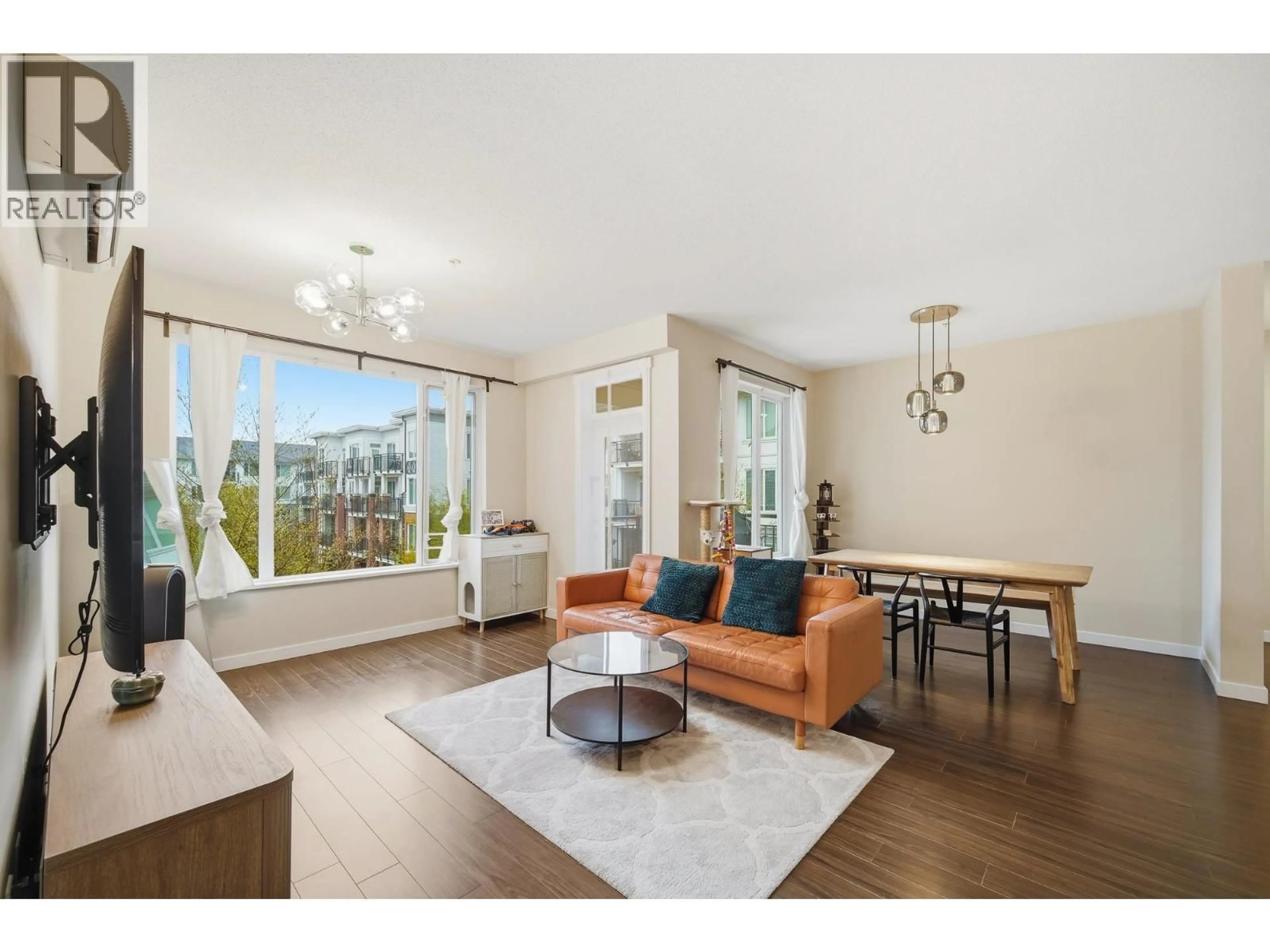 Living room with furniture, wood/laminate floor for 339 - 9388 MCKIM WAY, Richmond British Columbia V6X0J7