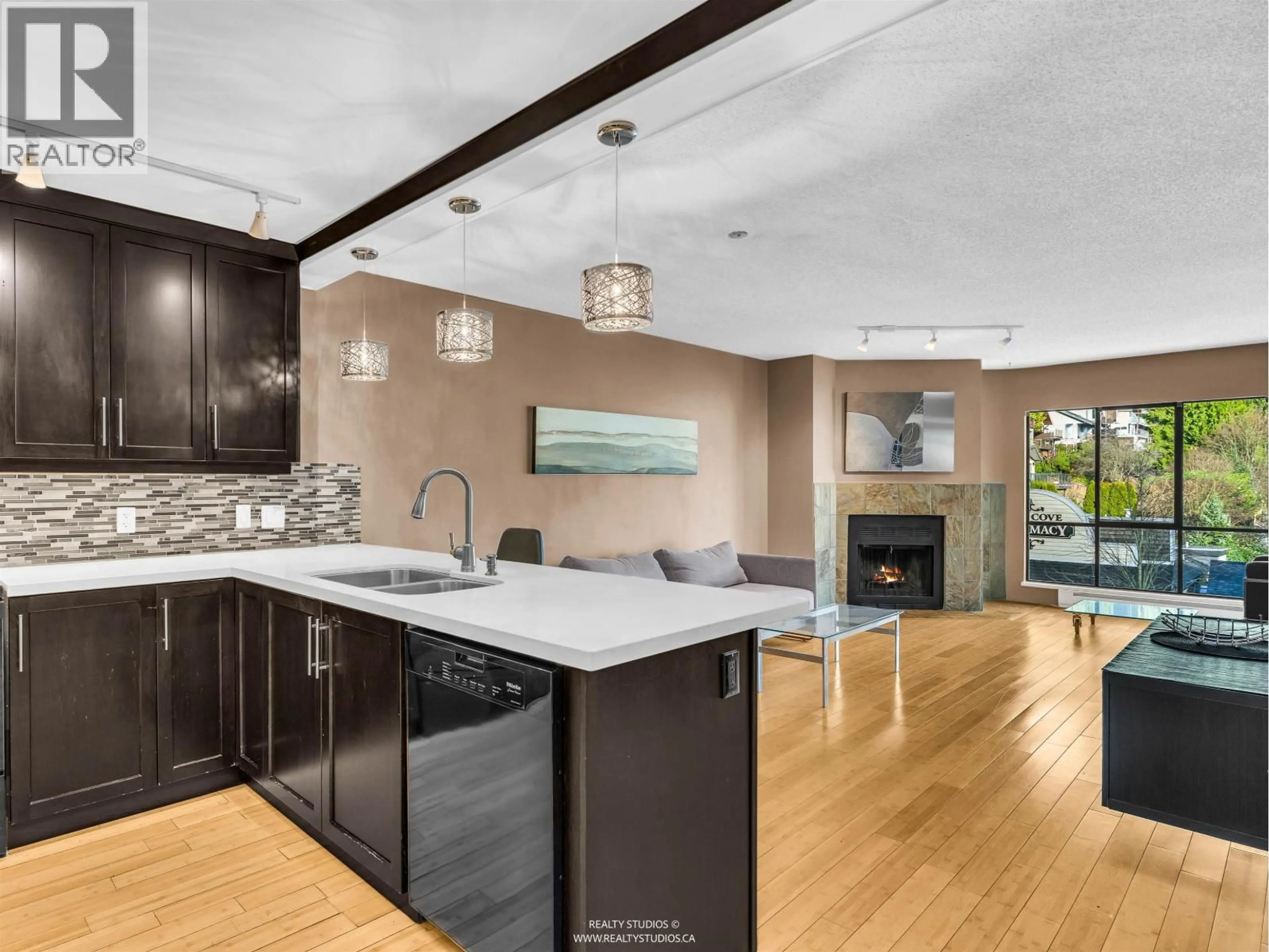 Open concept kitchen, unknown for 203 - 4323 GALLANT AVENUE, North Vancouver British Columbia V7G2C1