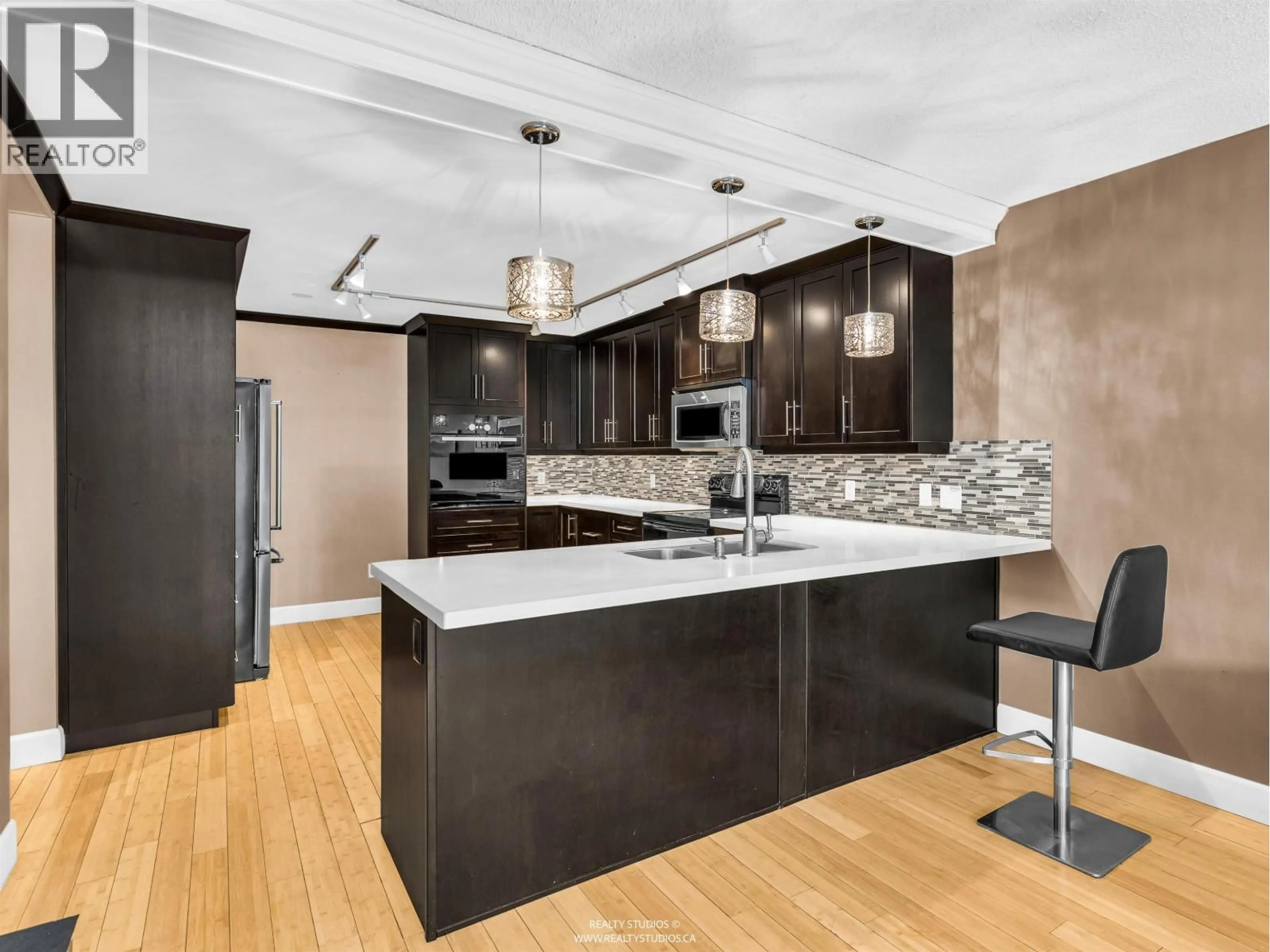 Contemporary kitchen, unknown for 203 - 4323 GALLANT AVENUE, North Vancouver British Columbia V7G2C1