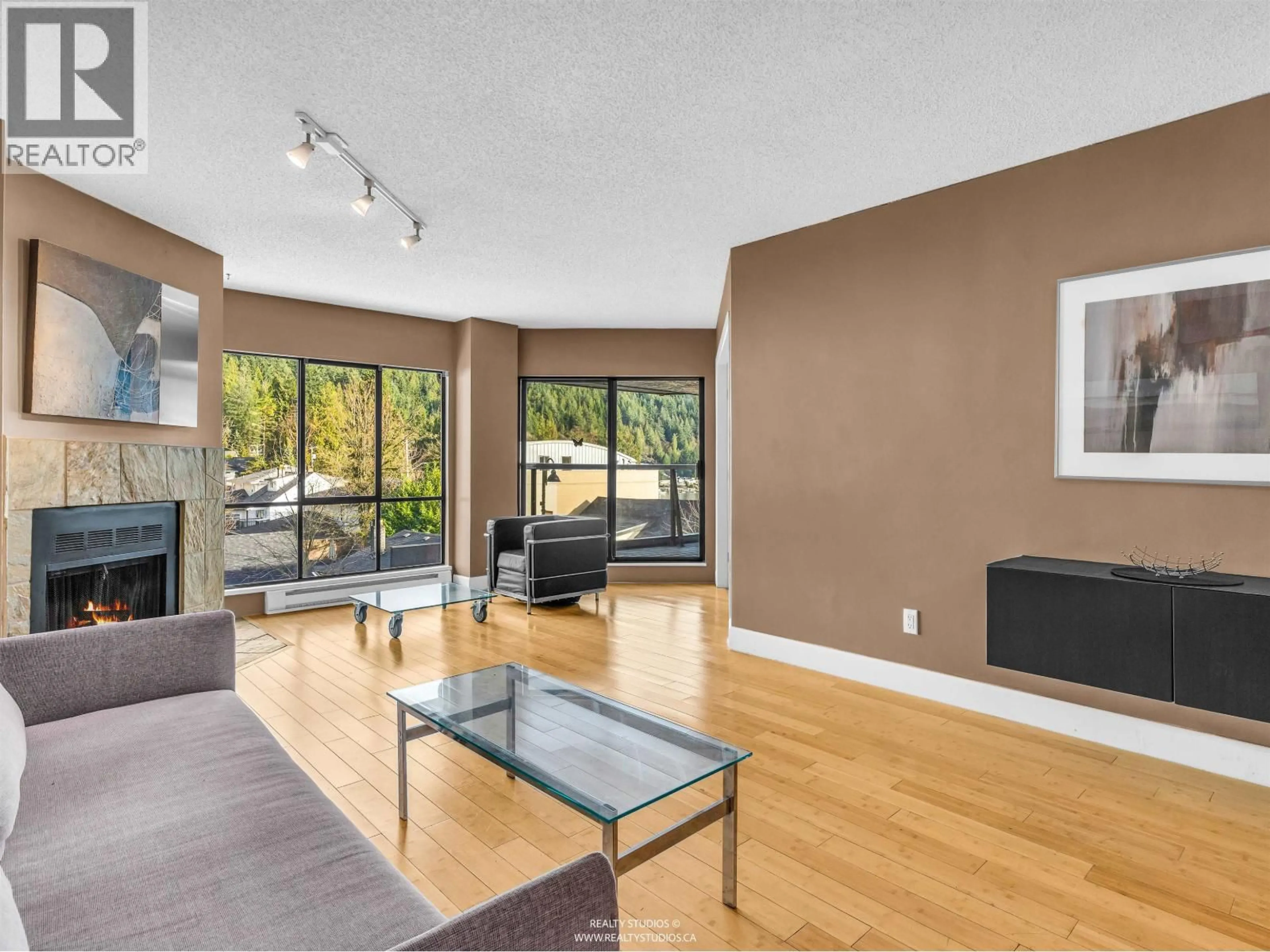 Living room with furniture, wood/laminate floor for 203 - 4323 GALLANT AVENUE, North Vancouver British Columbia V7G2C1