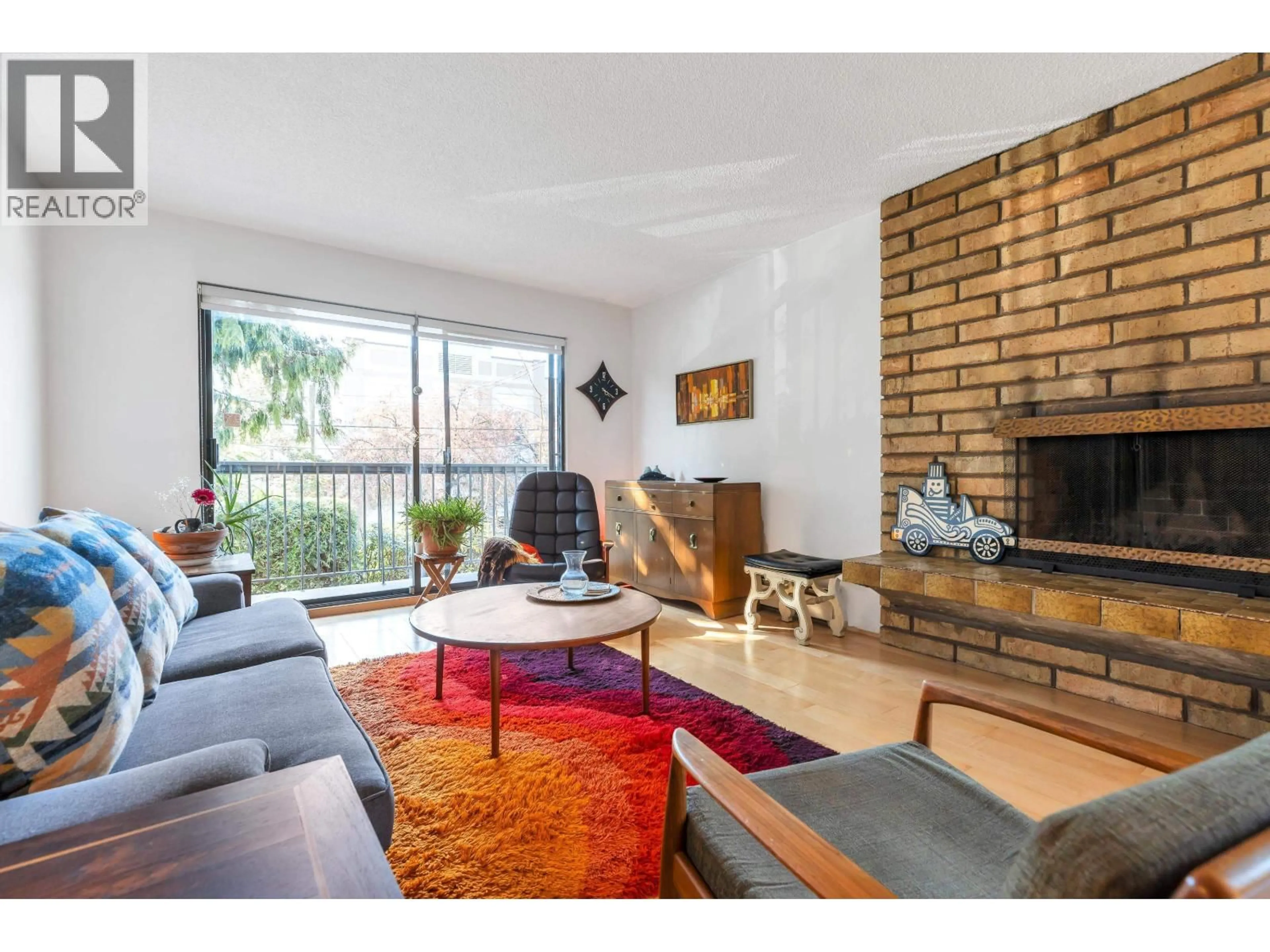 Living room with furniture, wood/laminate floor for 204 - 1515 5TH AVENUE, Vancouver British Columbia V5N1L6