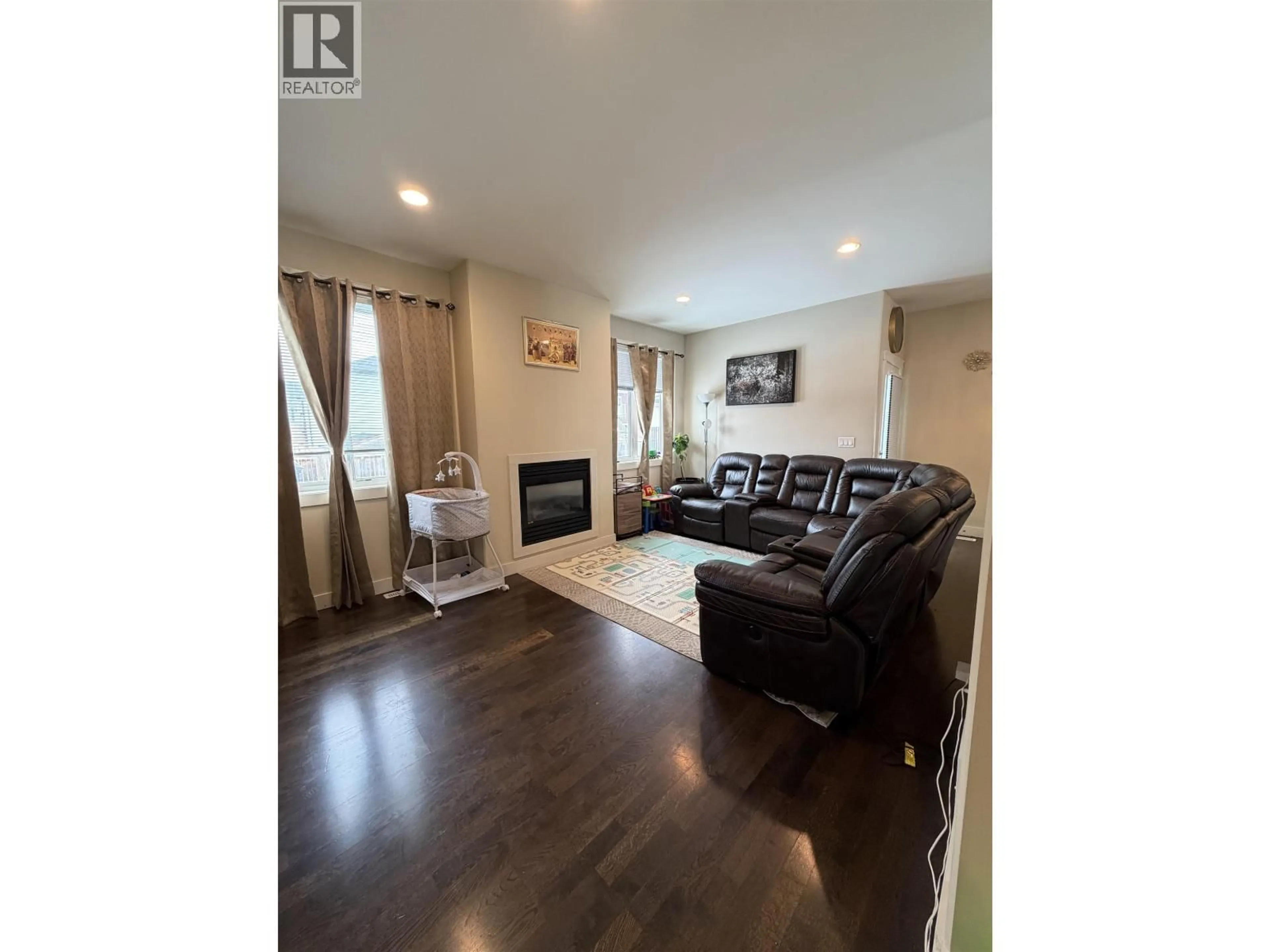 Living room with furniture, wood/laminate floor for 10611 109A STREET, Fort St. John British Columbia V1J0L2