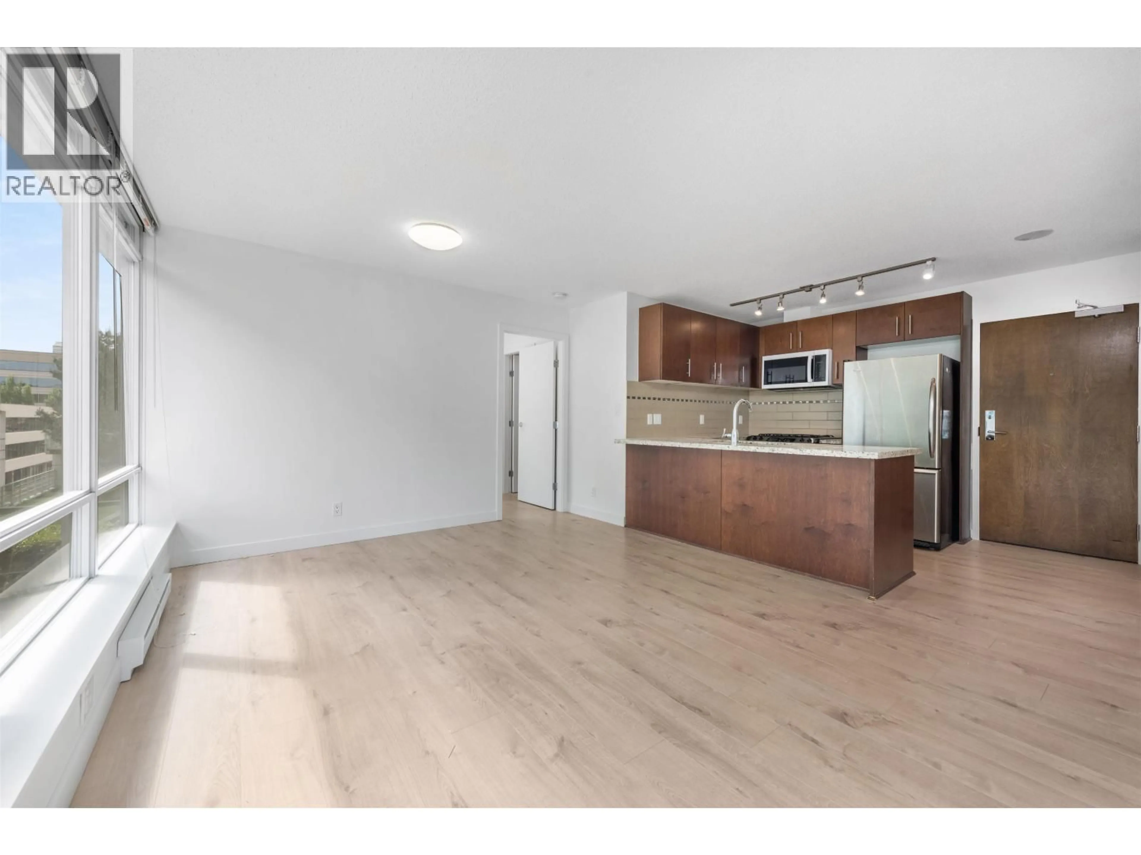 Open concept kitchen, wood/laminate floor for 511 - 8280 LANSDOWNE ROAD, Richmond British Columbia V6X0B2