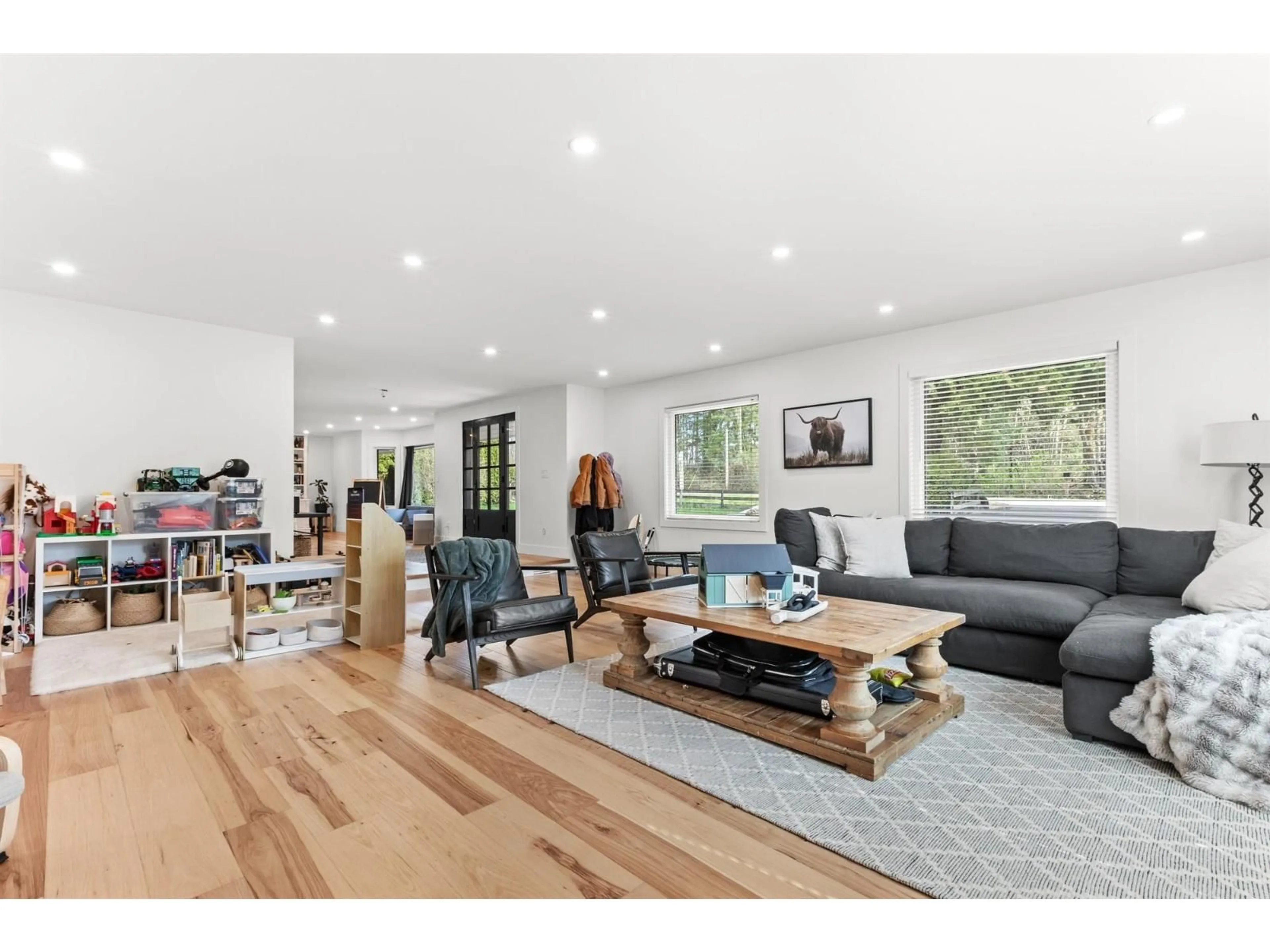 Living room with furniture, wood/laminate floor for 7025 HESSLEA CRESCENT, Abbotsford British Columbia V4X2C2