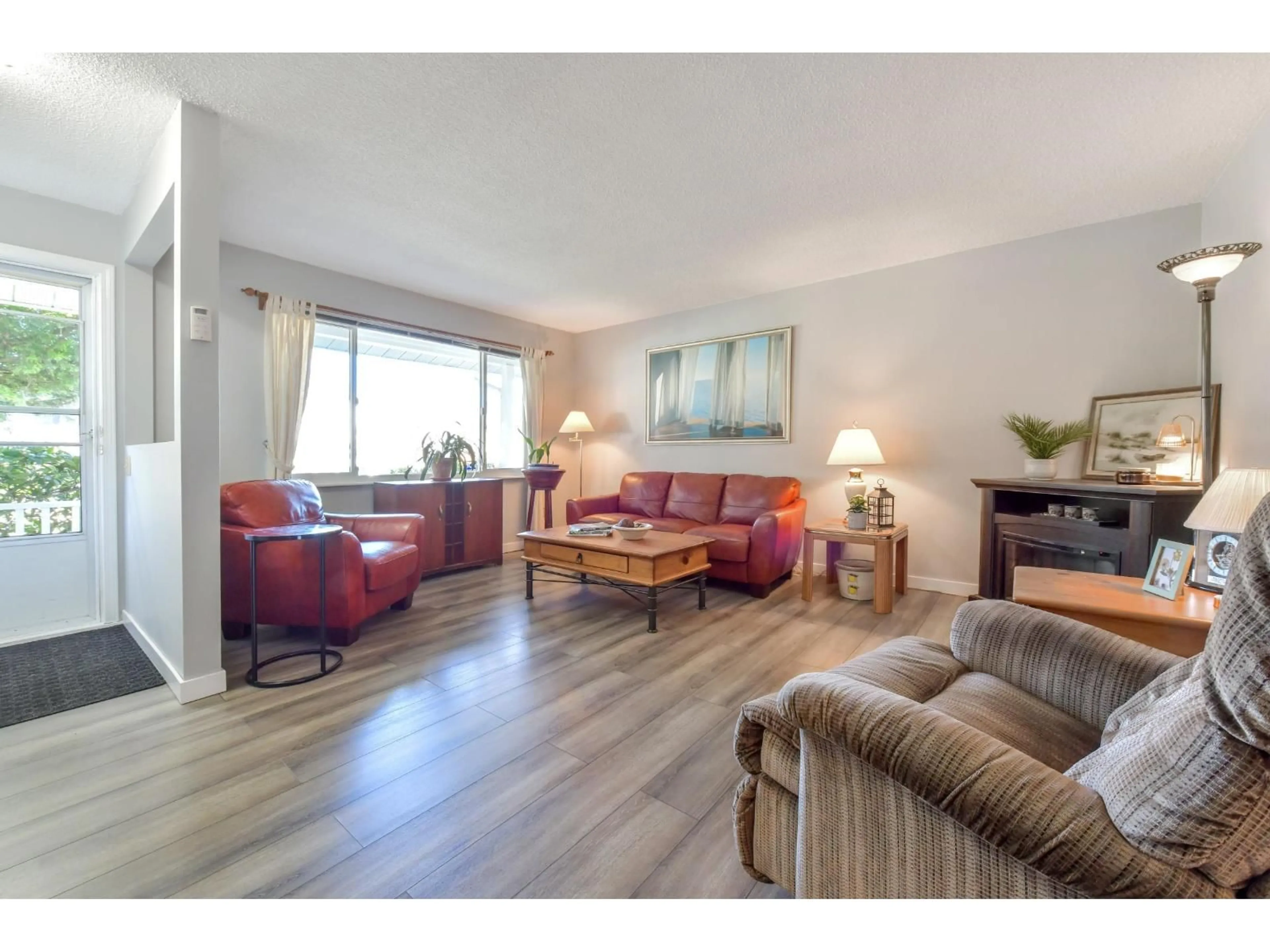 Living room with furniture, wood/laminate floor for 6336 CHARBRAY PLACE, Surrey British Columbia V3S5H6