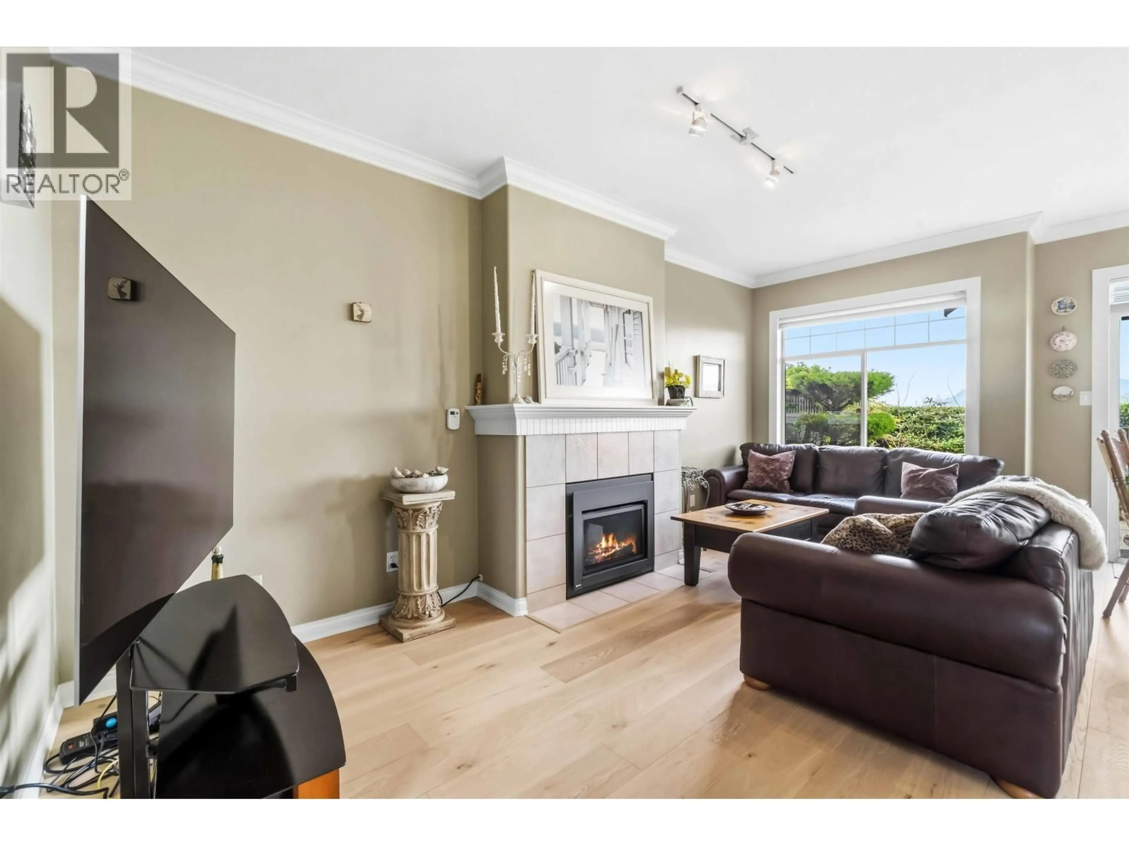 Living room with furniture, wood/laminate floor for 31 - 5531 CORNWALL DRIVE, Richmond British Columbia V7C5N7