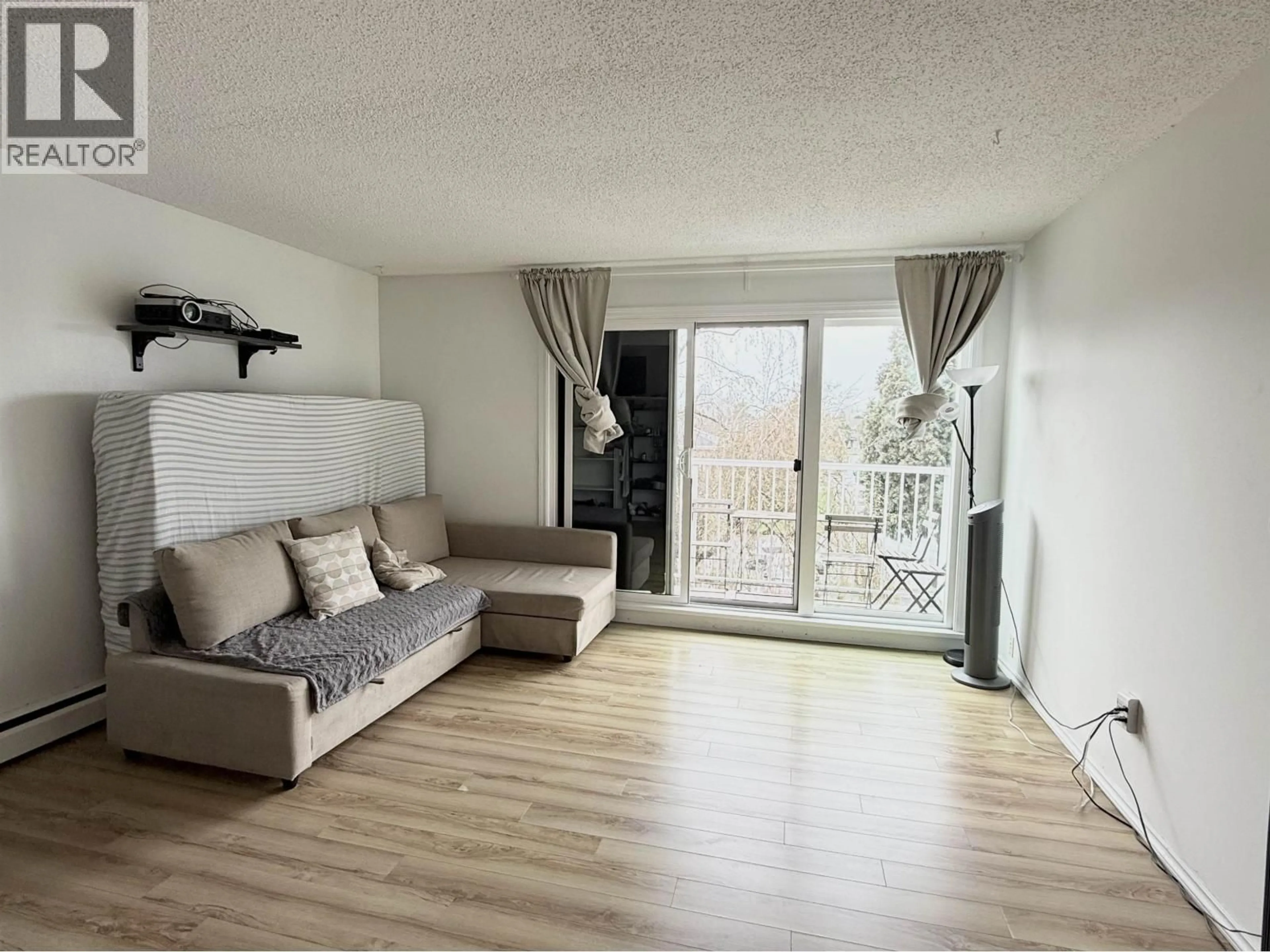 Living room with furniture, wood/laminate floor for 304 - 7280 LINDSAY ROAD, Richmond British Columbia V7C3M6