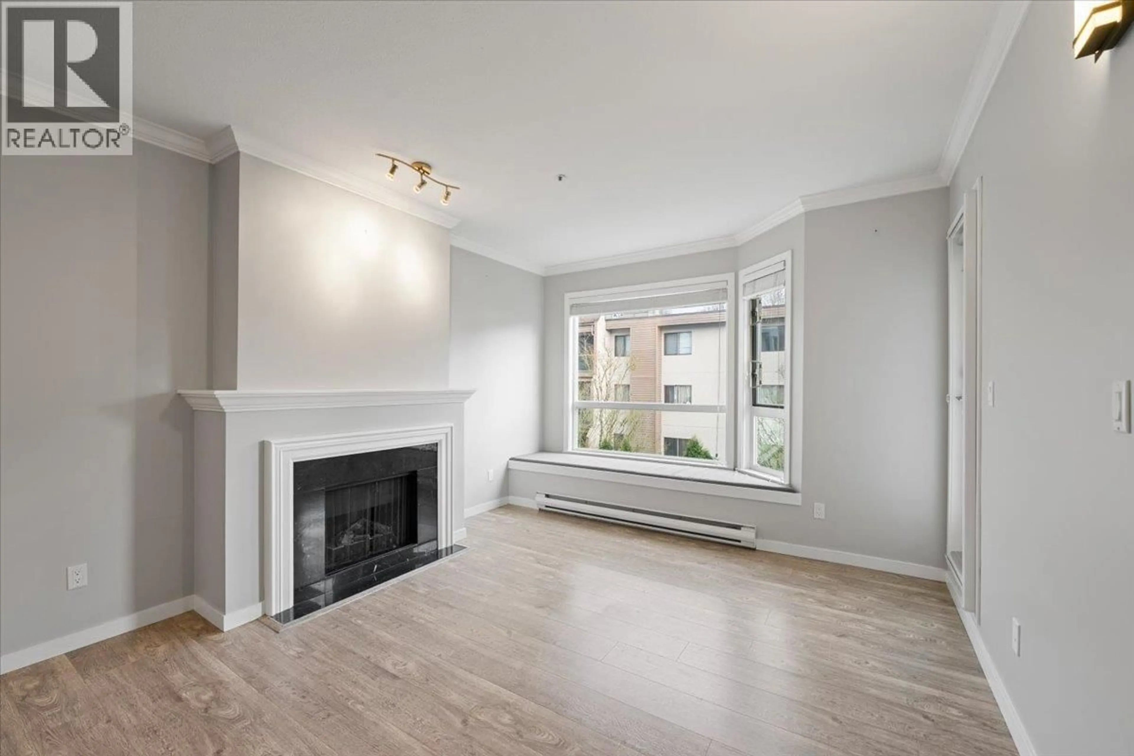 Living room with furniture, wood/laminate floor for 204 - 8680 LANSDOWNE ROAD, Richmond British Columbia V6X1B9