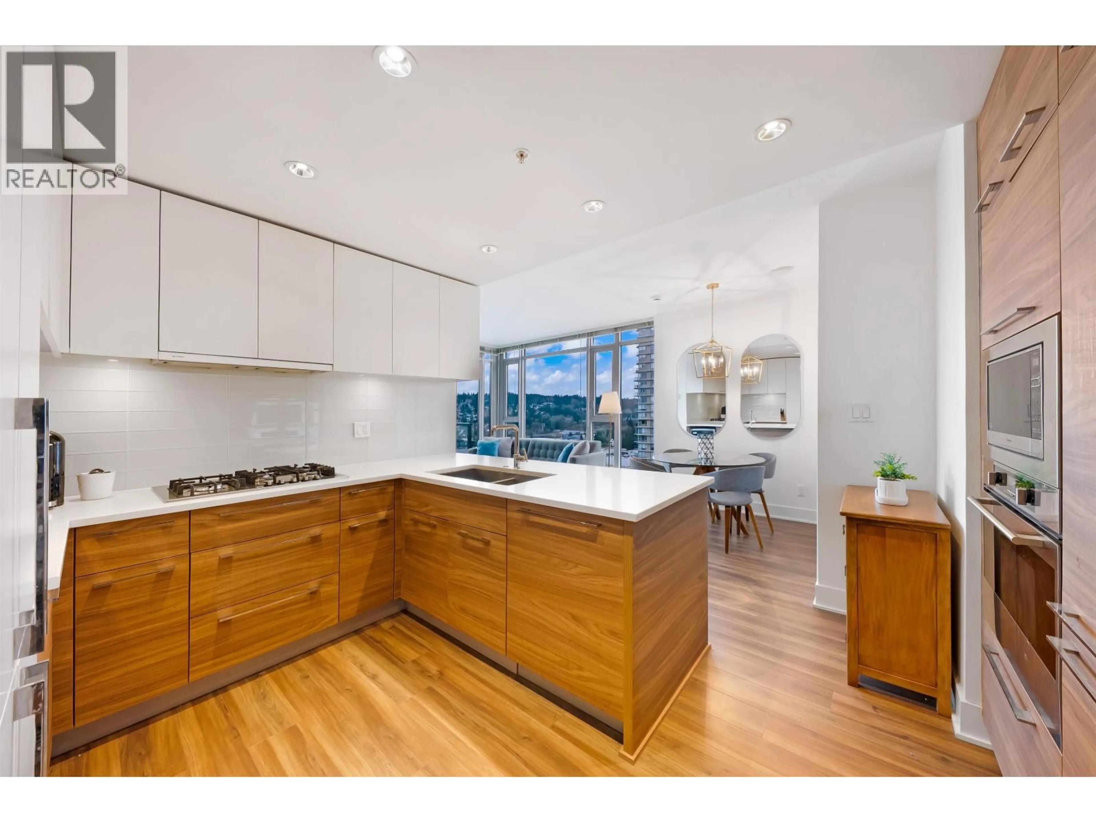 Open concept kitchen, wood/laminate floor for 2502 - 1188 PINETREE WAY, Coquitlam British Columbia V3B0K9