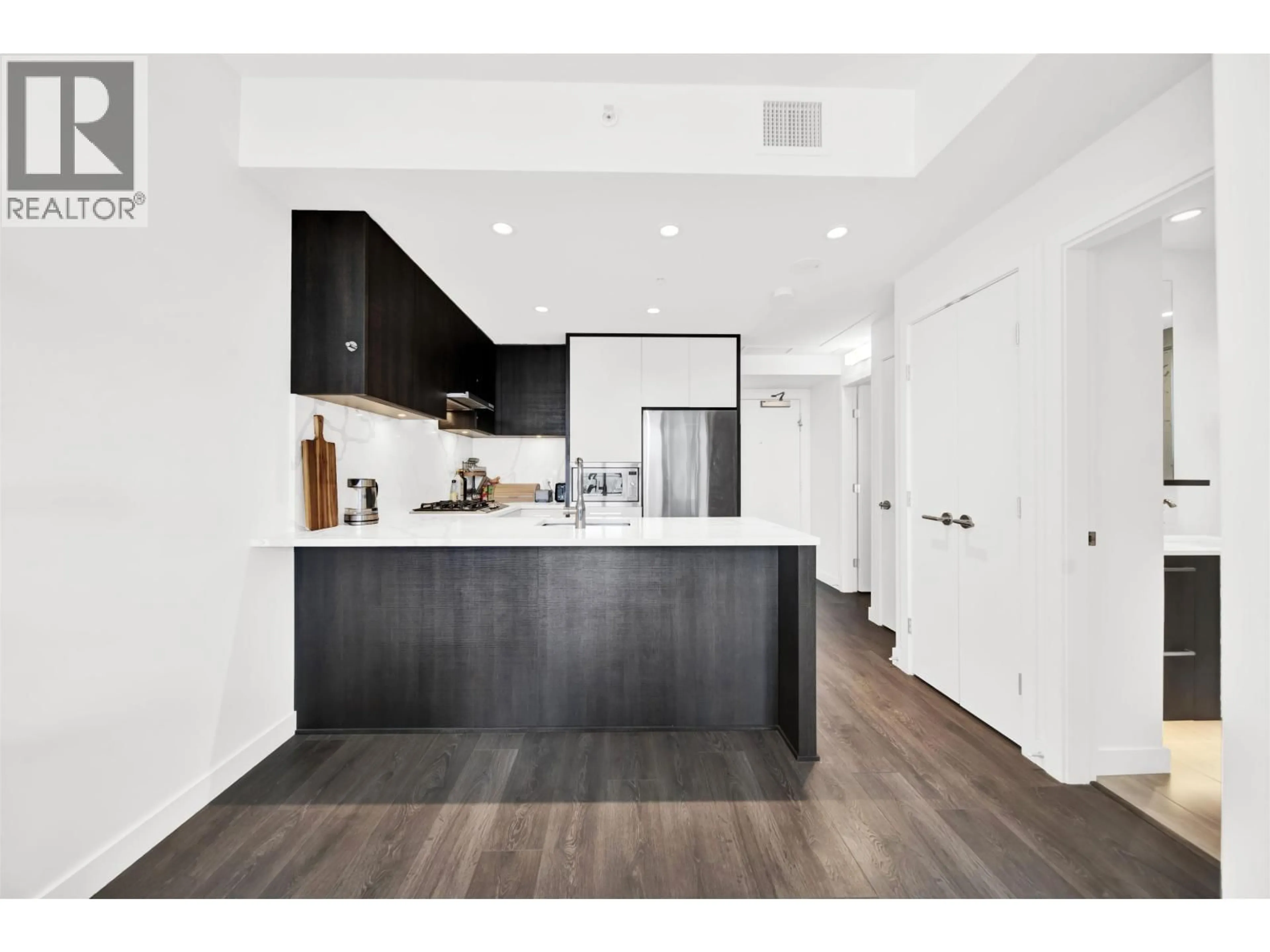 Open concept kitchen, wood/laminate floor for 2005 - 567 CLARKE ROAD, Coquitlam British Columbia V3J0K7