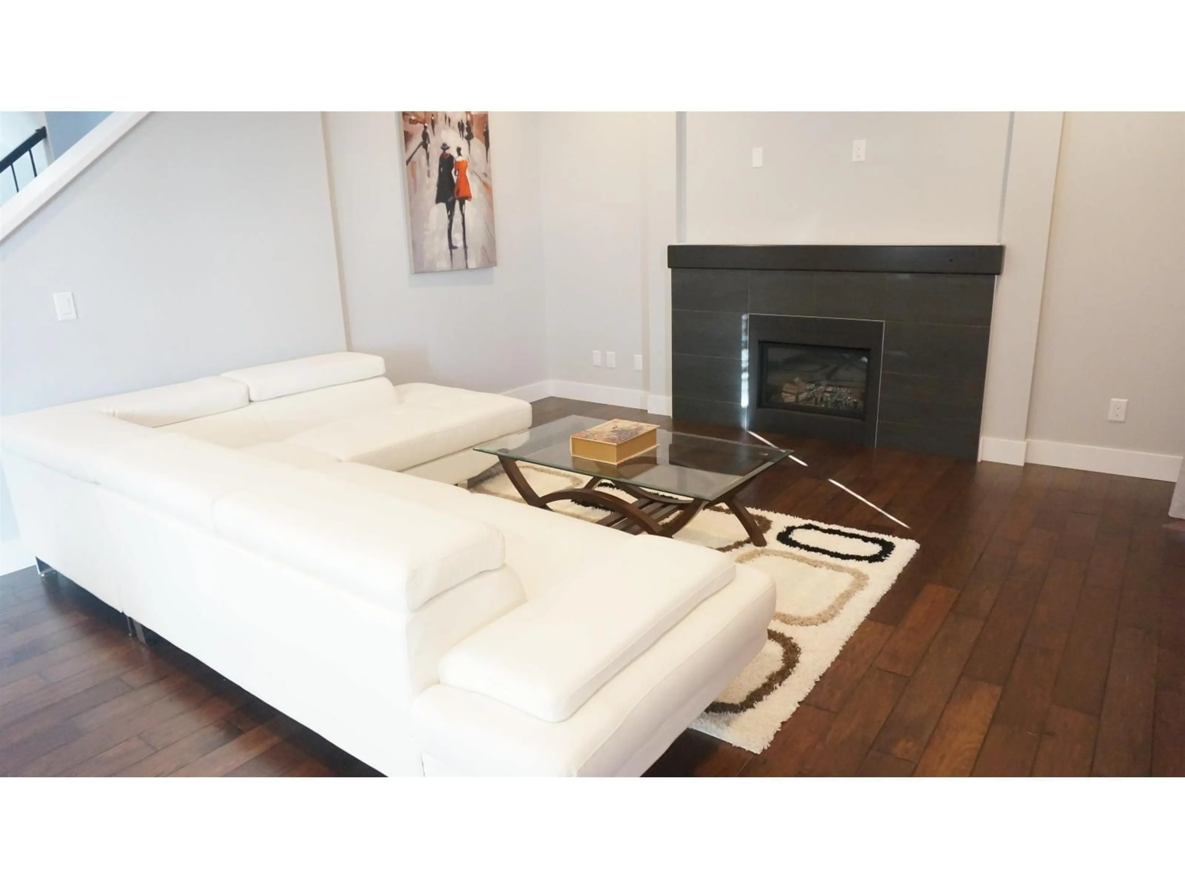Living room with furniture, wood/laminate floor for 16988 77A AVENUE, Surrey British Columbia V4N6L2