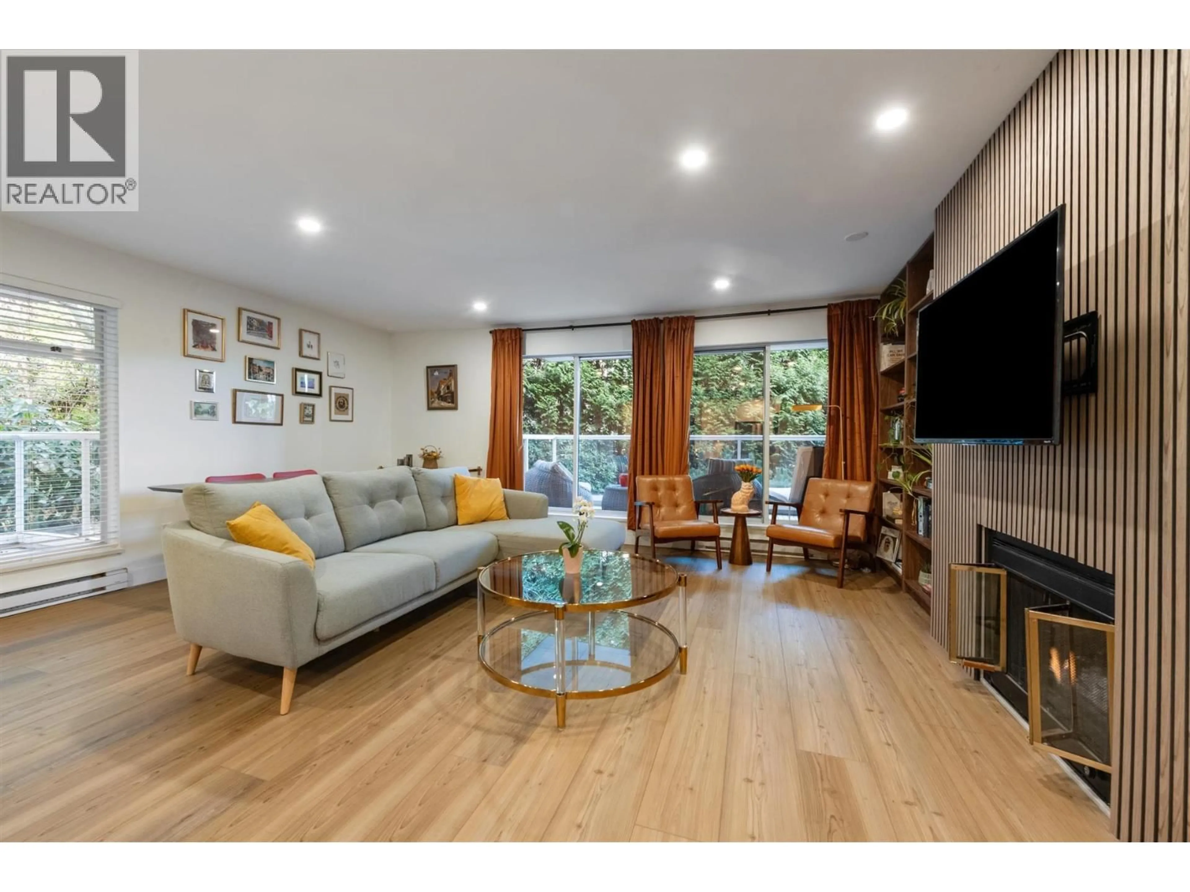 Living room with furniture, wood/laminate floor for 208 - 2733 ATLIN PLACE, Coquitlam British Columbia V3C5B1