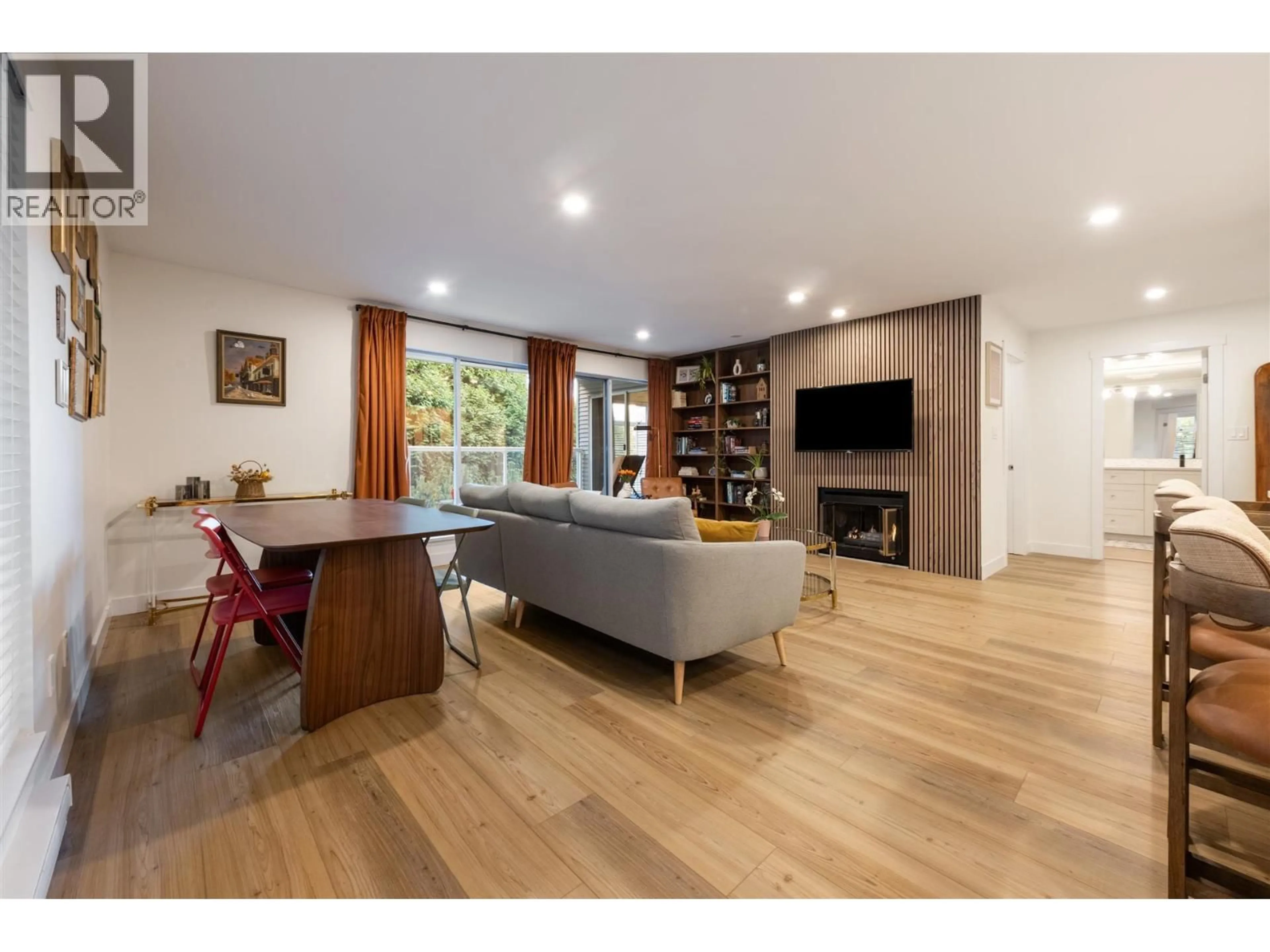 Living room with furniture, wood/laminate floor for 208 - 2733 ATLIN PLACE, Coquitlam British Columbia V3C5B1