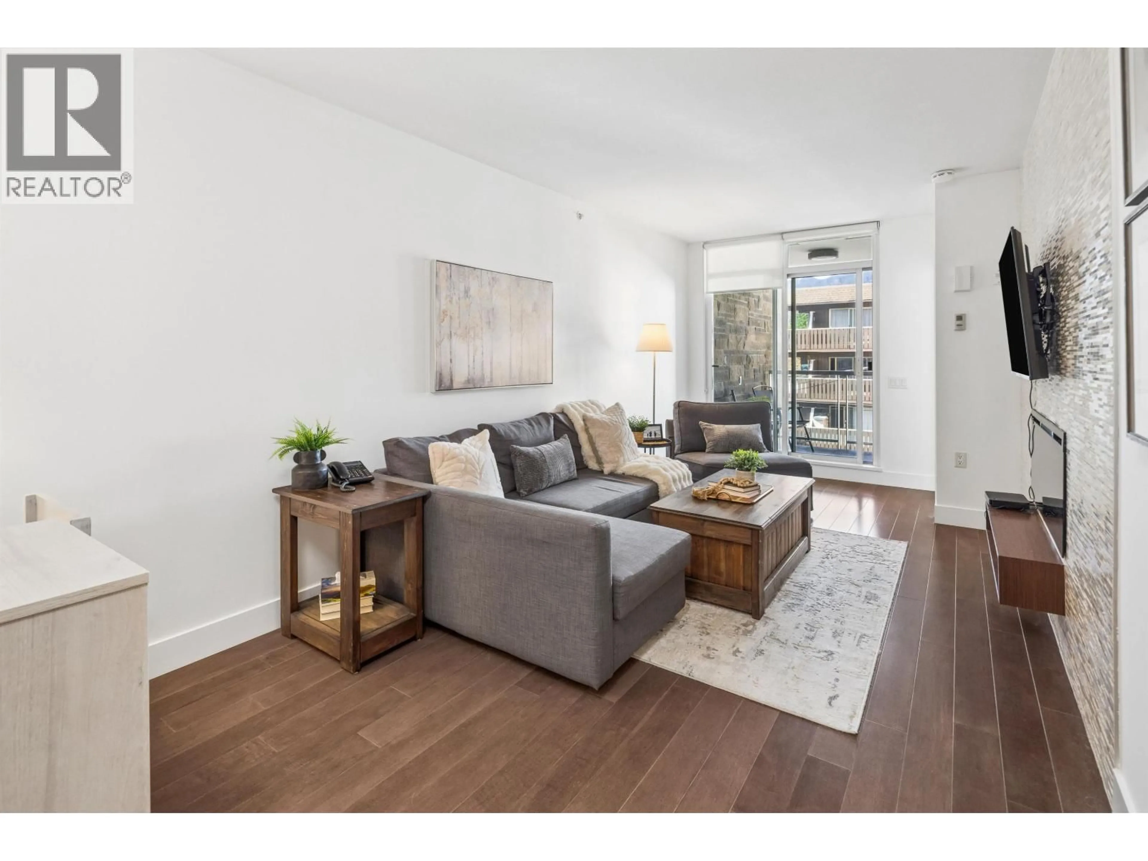 Living room with furniture, wood/laminate floor for 406 - 210 13 STREET, North Vancouver British Columbia V7M1N7