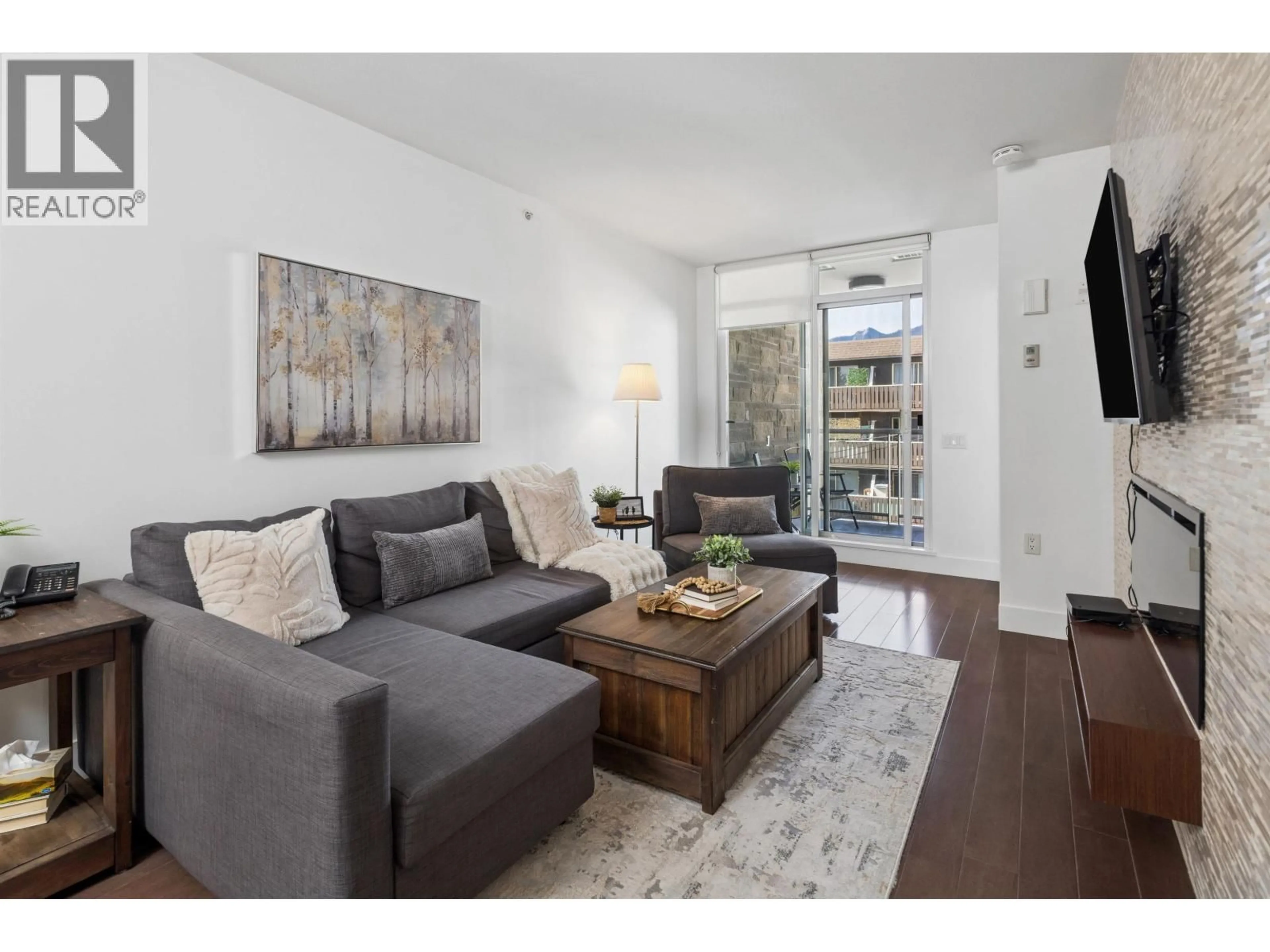 Living room with furniture, wood/laminate floor for 406 - 210 13 STREET, North Vancouver British Columbia V7M1N7