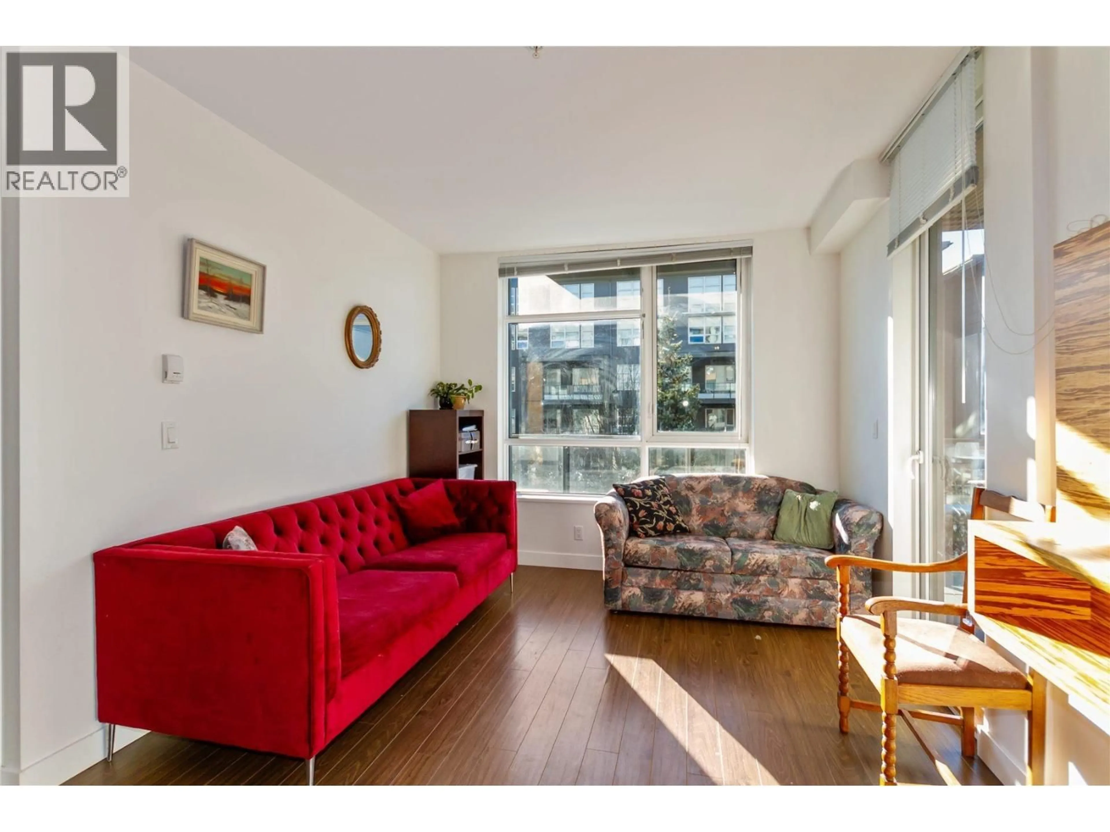 Living room with furniture, wood/laminate floor for 101 - 9150 UNIVERSITY HIGH STREET, Burnaby British Columbia V5A0C5