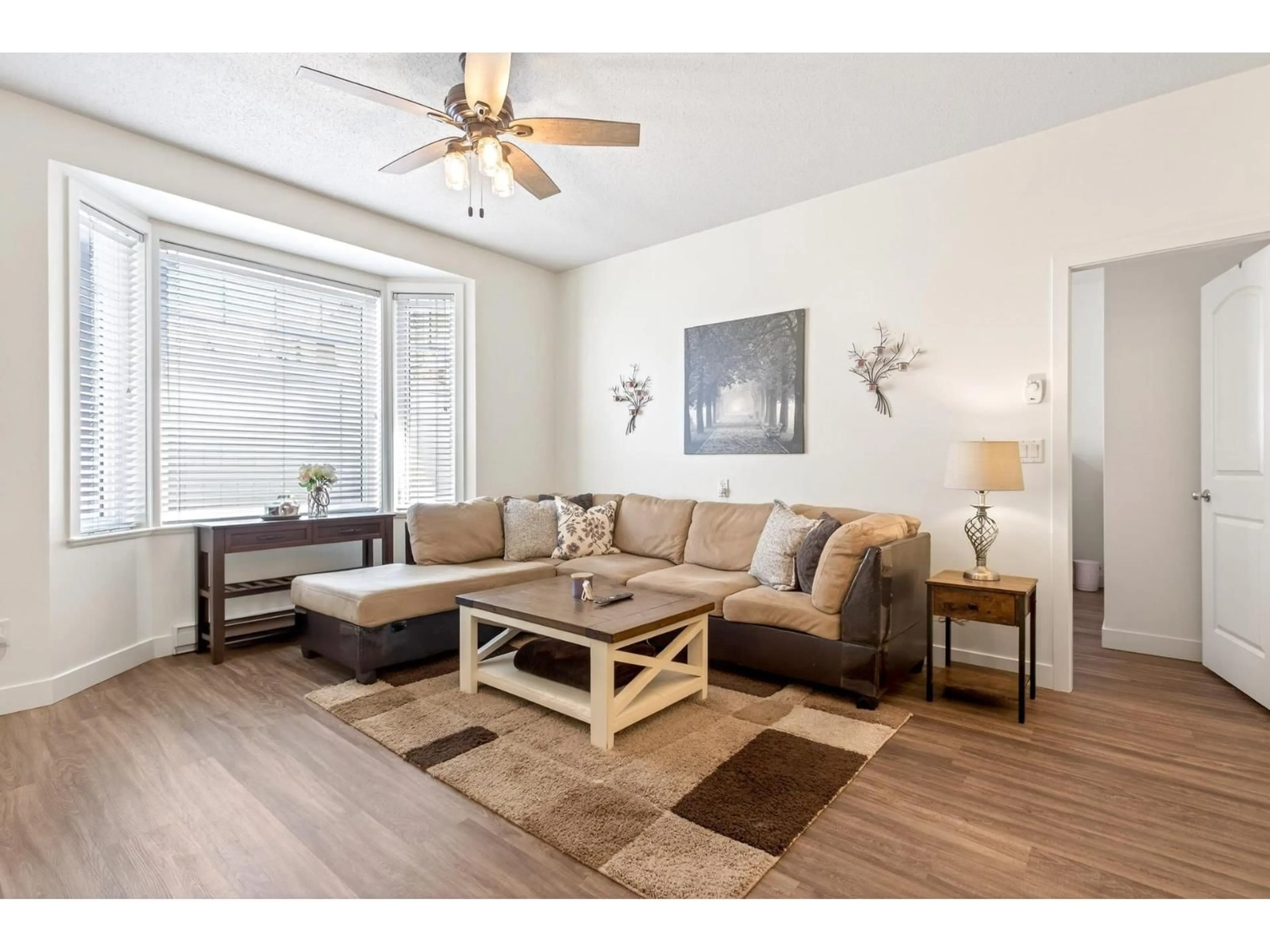 Living room with furniture, wood/laminate floor for 22 - 32501 FRASER CRESCENT, Mission British Columbia V2V1C5