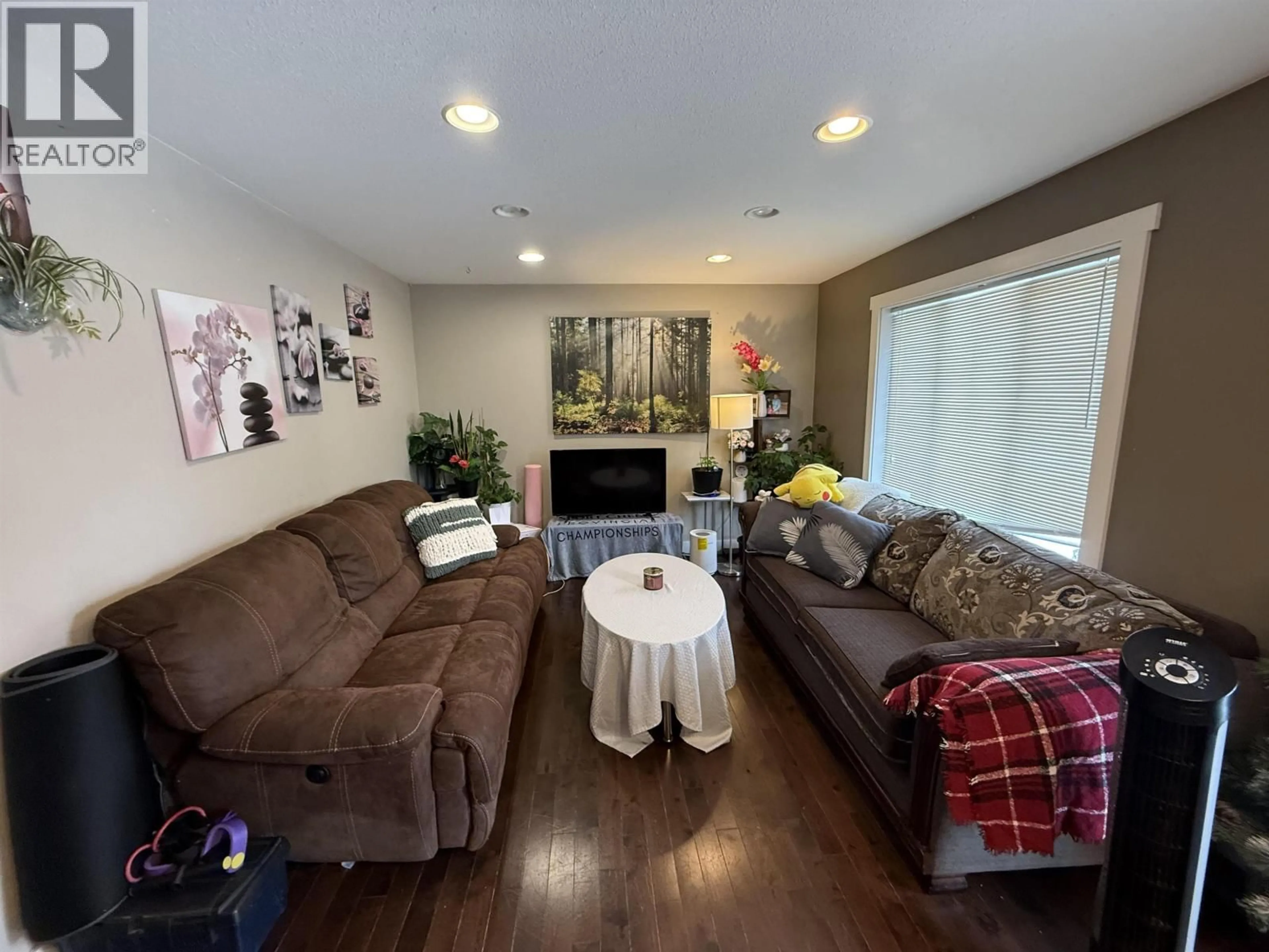 Living room with furniture, wood/laminate floor for 10507 109 STREET, Fort St. John British Columbia V1J0J3
