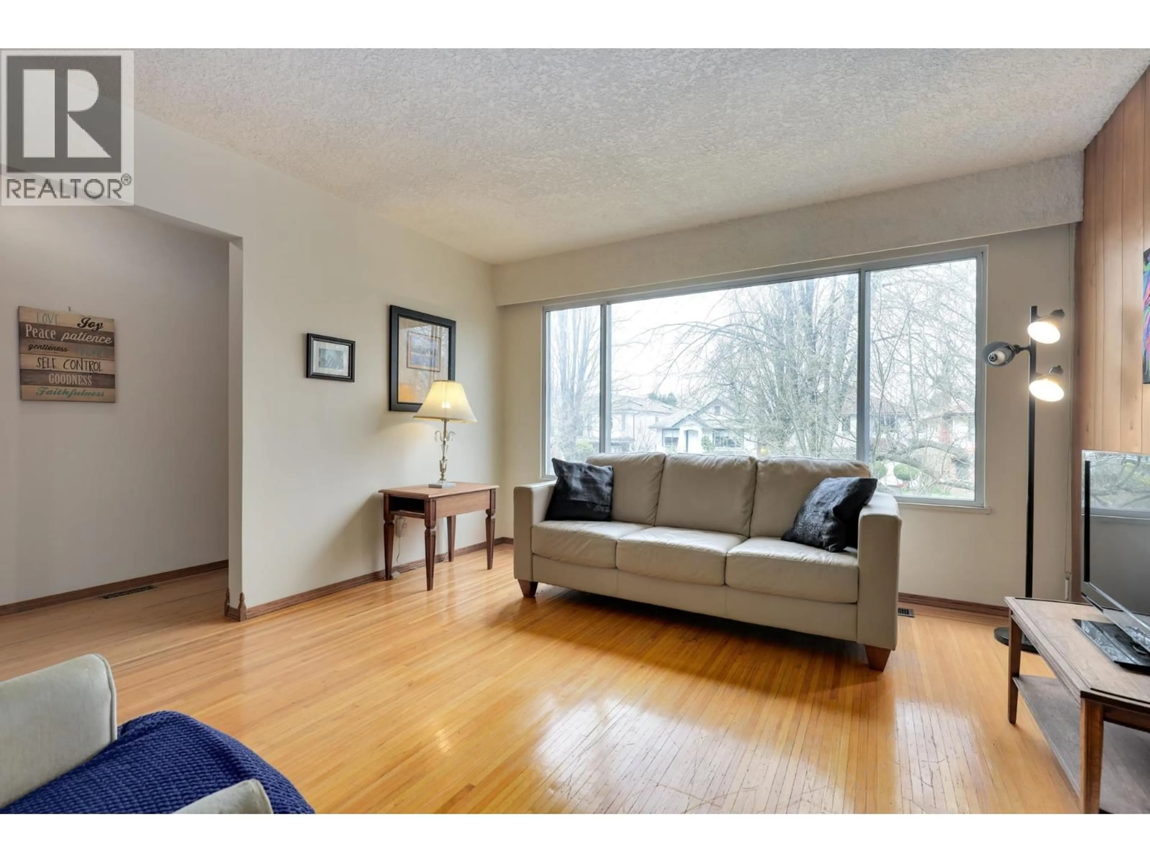 Living room with furniture, wood/laminate floor for 5884 ORMIDALE STREET, Vancouver British Columbia V5R4R3