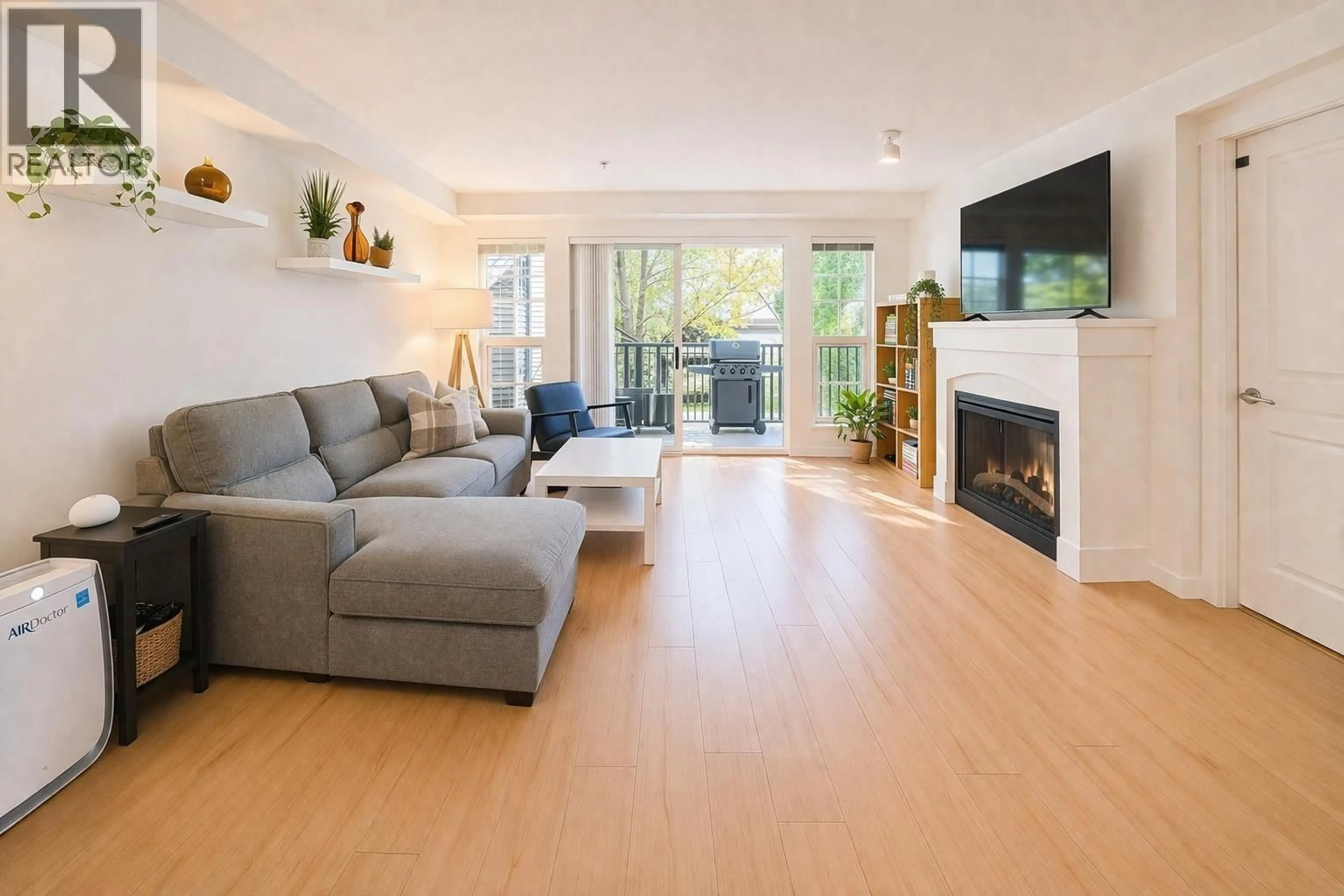 Living room with furniture, wood/laminate floor for 208 - 2958 SILVER SPRINGS BOULEVARD, Coquitlam British Columbia V3E3R9