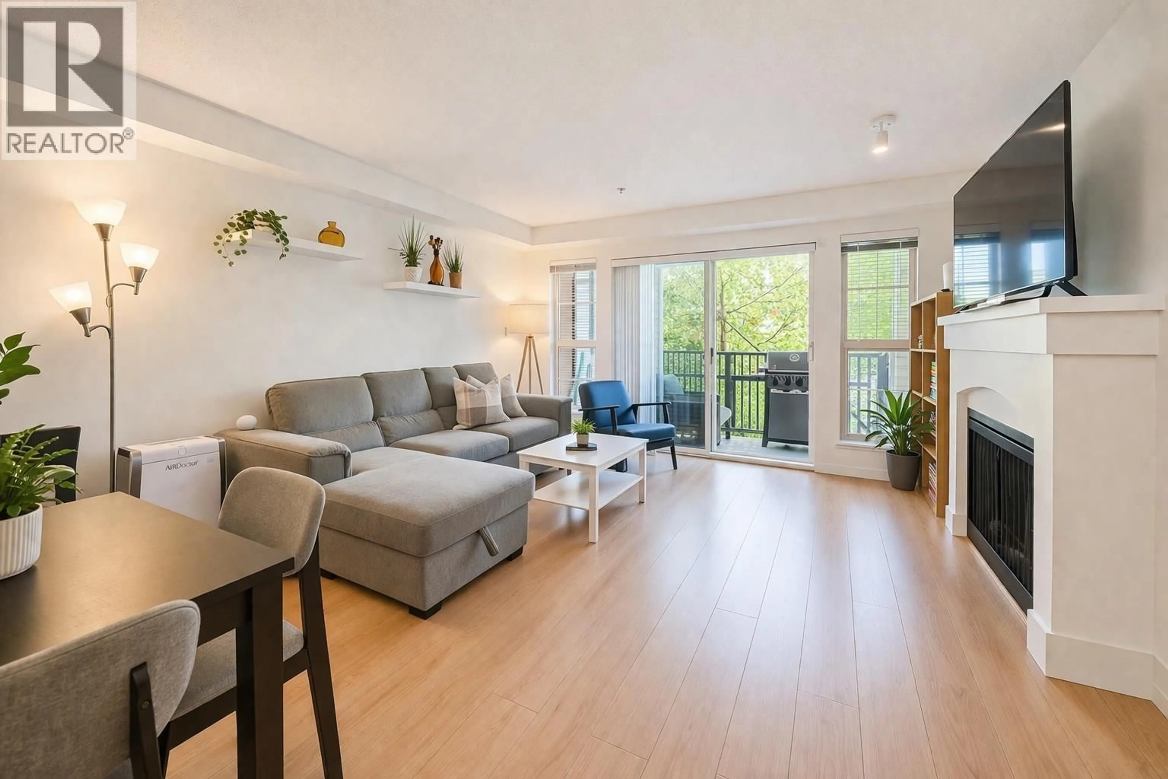 Living room with furniture, wood/laminate floor for 208 - 2958 SILVER SPRINGS BOULEVARD, Coquitlam British Columbia V3E3R9