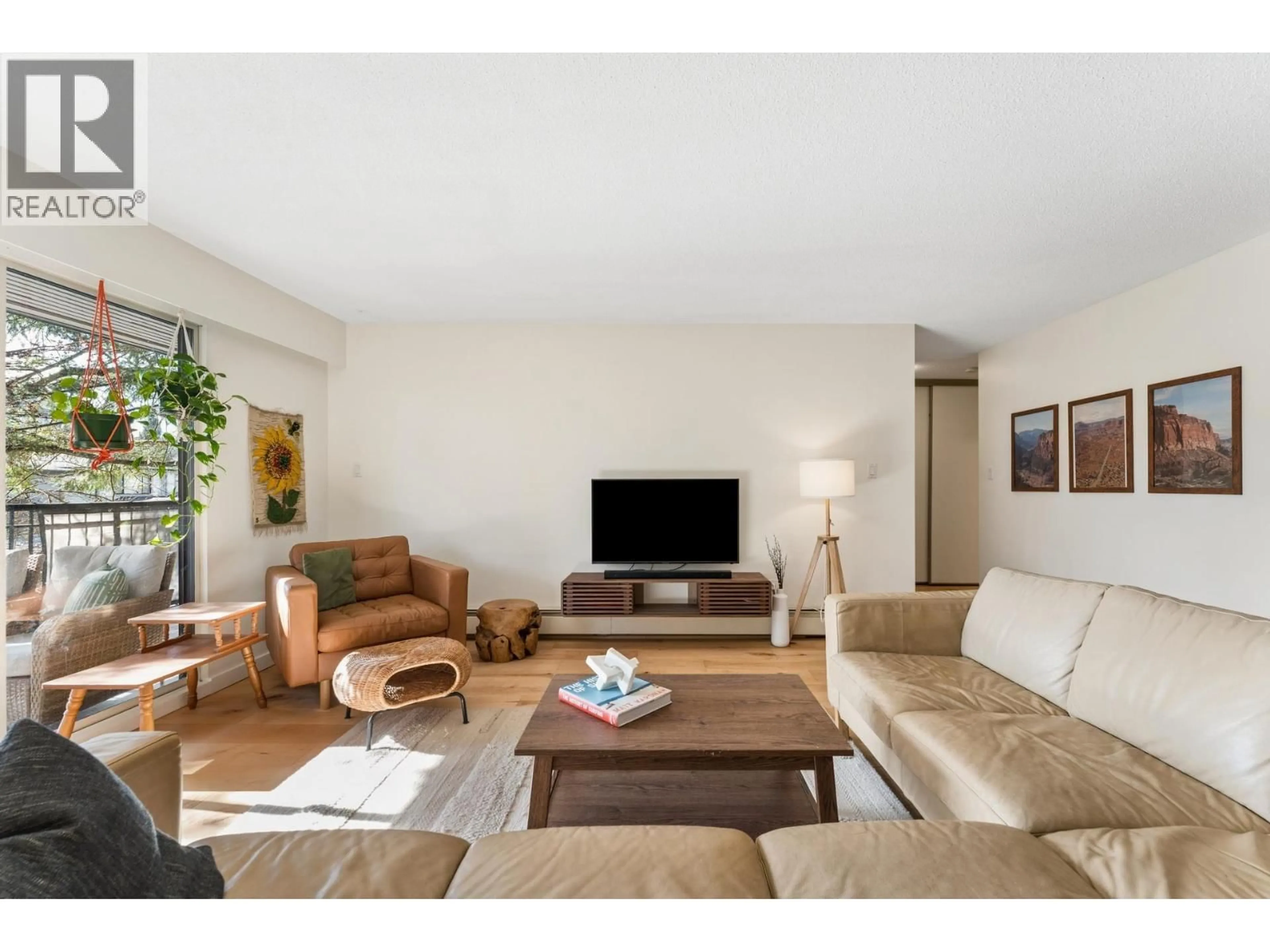 Living room with furniture, wood/laminate floor for 211 - 1385 DRAYCOTT ROAD, North Vancouver British Columbia V7J3K9