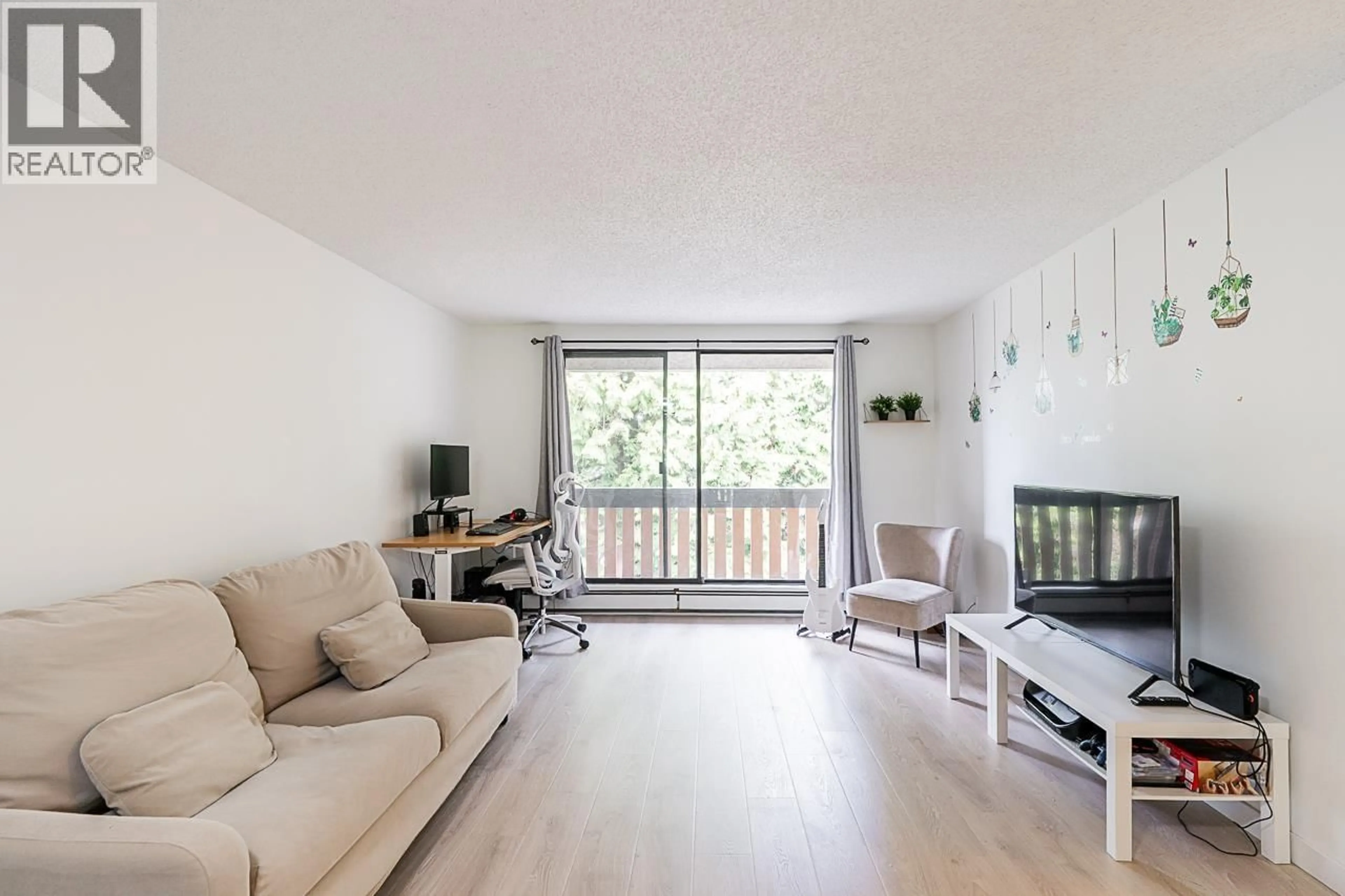 Living room with furniture, wood/laminate floor for 210 - 8640 CITATION DRIVE, Richmond British Columbia V6Y3A3